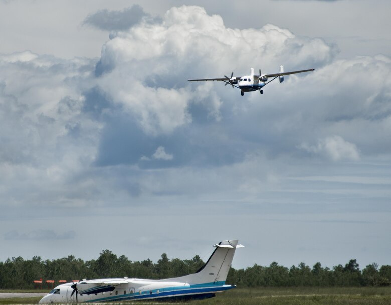 A C-145A Skytruck comes in for a landing as a C-146 Wolfhound waits to take off Aug. 31 at Duke Field, Fla.  The Skytruck is a special operations training aircraft and the Wolfhound is used in nonstandard aviation operations.  (U.S. Air Force photo/Tech. Sgt. Sam King)