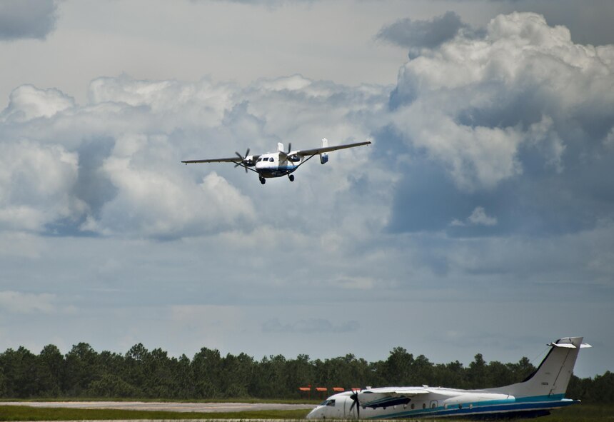 A C-145A Skytruck comes in for a landing as a C-146 Wolfhound waits to take off Aug. 31 at Duke Field, Fla.  The Skytruck is a special operations training aircraft and the Wolfhound is used in nonstandard aviation operations.  (U.S. Air Force photo/Tech. Sgt. Sam King)
