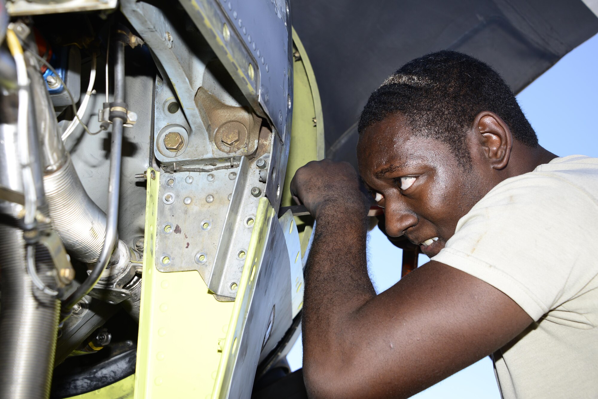 U.S. Air Force Senior Airman George Thompson, 755th Aircraft Maintenance Squadron aerospace propulsion journeyman, adjusts a bolt while installing a new chin scoop on an EC-130H Compass Call at Davis-Monthan Air Force Base, Ariz., Aug. 31, 2016. The 755th AMXS is part of the 55th Electronic Combat Group, a geographically separated unit out of Offutt AFB, Neb. (U.S. Air Force photo by Senior Airman Betty R. Chevalier)