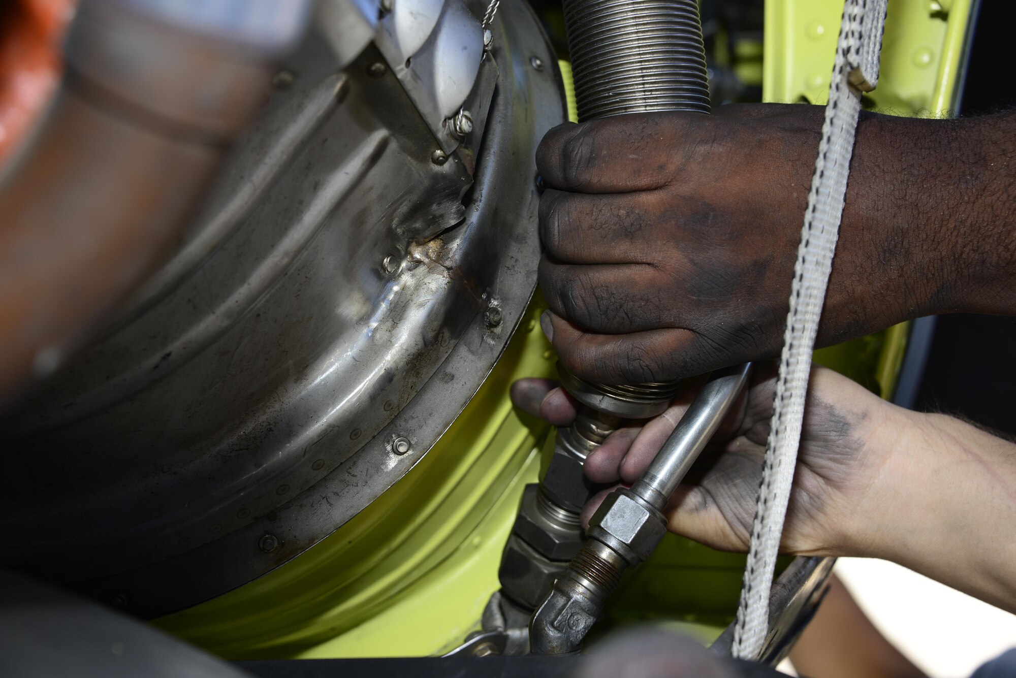 U.S. Airmen from the 755th Aircraft Maintenance Squadron reconnect a hose during the installation of a chin scoop on an EC-130H Compass Call at Davis-Monthan Air Force Base, Ariz., Aug. 31, 2016. The 755th AMXS plans and executes all equipment maintenance actions for Compass Call aircraft including launch and recovery, scheduled inspections and component replacement. (U.S. Air Force photo by Senior Airman Betty R. Chevalier)