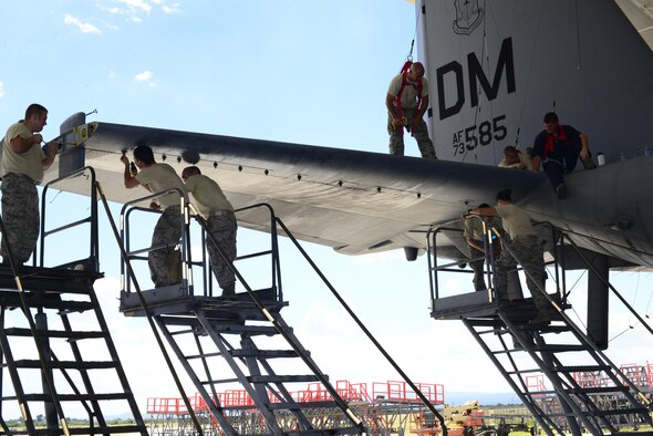U.S. Airmen from the 755th Aircraft Maintenance Squadron work together to remove the panel on the right horizontal stabilizer of an EC-130H Compass Call at Davis-Monthan Air Force Base, Ariz., Aug. 30, 2016. The 755th AMXS plans and executes all equipment maintenance actions for 14 Compass Call aircraft. (U.S. Air Force photo by Senior Airman Betty R. Chevalier)