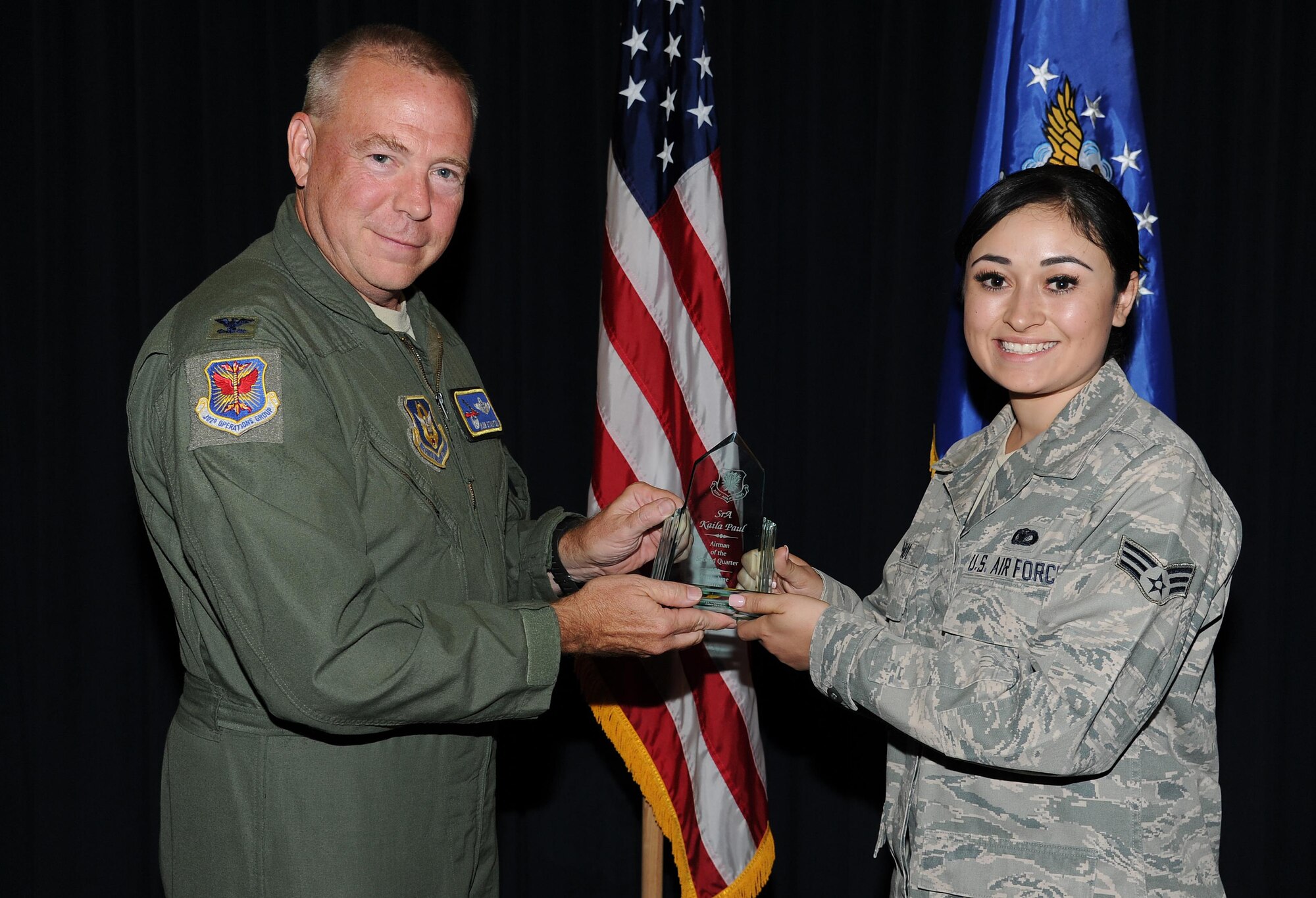 PETERSON AIR FORCE BASE, Colo.— Senior Airman Kaila Paul (right), a 302nd Airlift Wing Reservist assigned to the 302nd Security Forces Squadron, was awarded the 302nd AW Airman of the Second Quarter Award, 2016, by Col. Robert Stanton Aug. 7, 2016 here. Stanton, 302nd Operations Group commander, recognized the quarterly award winners during the August Unit Training Assembly. The other 2016 Second Quarter Award winners are: noncommissioned officer – Staff Sgt. Christopher Michael, senior noncommissioned officer – Senior Master Sgt. Paul LaFleur, company grade officer – Capt. Katherine Schifani, and field grade officer – Maj. James Bishop. (U.S. Air Force photo/Staff Sgt. Amber Sorsek)