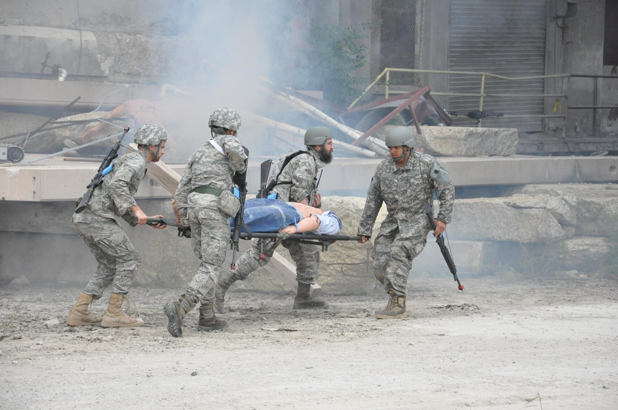 Air Force Research Laboratory Tech Warrior 2016 participants transport a casualty during a simulated battlefield scenario. The immersive experience is designed to give scientists and engineers insight into the battlefield environment in order to help in their design and function, of products and services, for the warfighter. (U.S. Air Force photo / Bill Hancock)