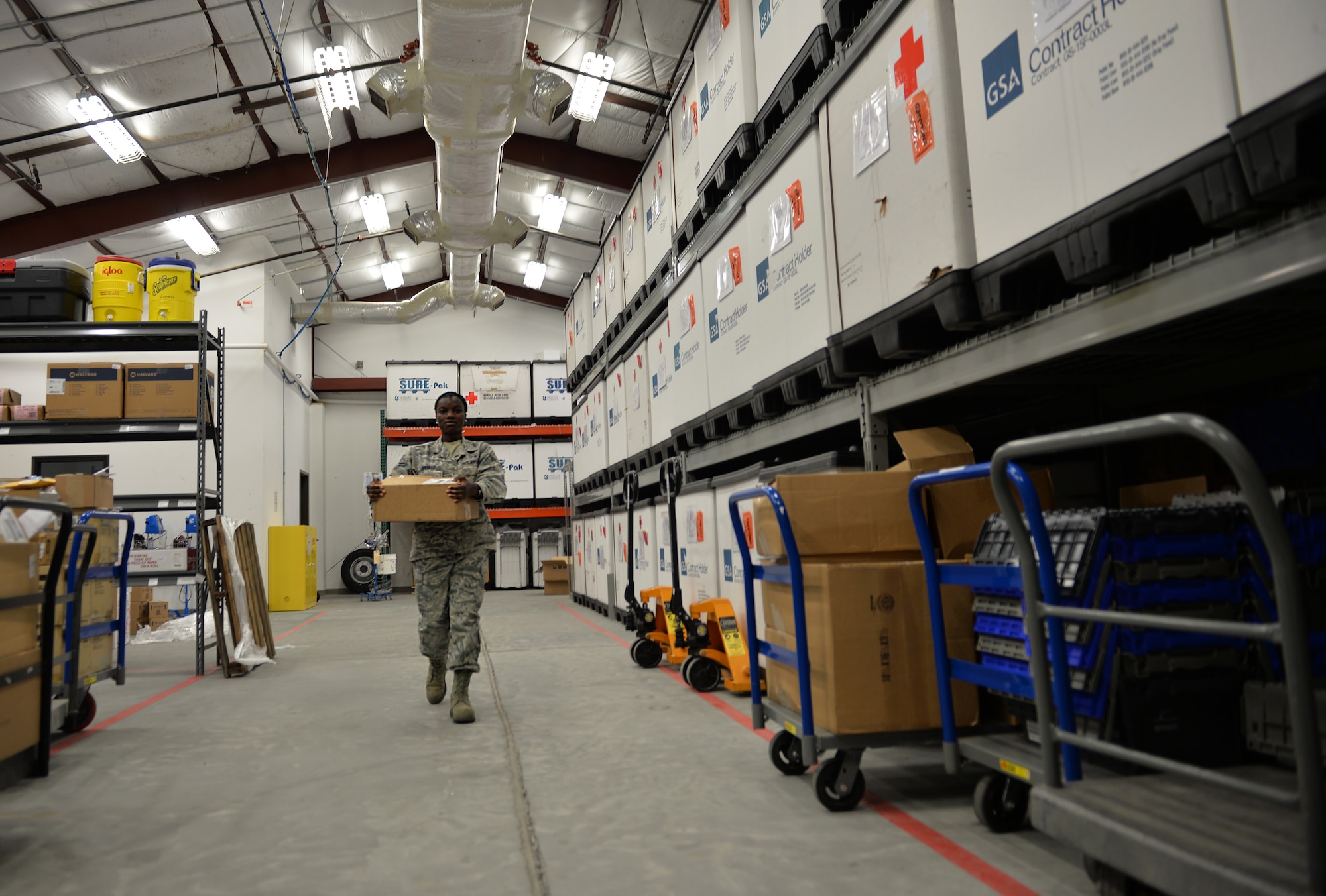 Airman 1st Class Temitope Odedele, a biomedical equipment technician assigned to the 1st Special Operations Medical Support Squadron, carries medical supplies to be stored at Hurlburt Field, Fla., Aug. 30, 2016. Biomedical equipment specialists are responsible for replacing parts, repairing components and inspecting equipment to ensure medical facilities have functioning supplies to sustain the force. (U.S. Air Force photo by Senior Airman Andrea Posey)