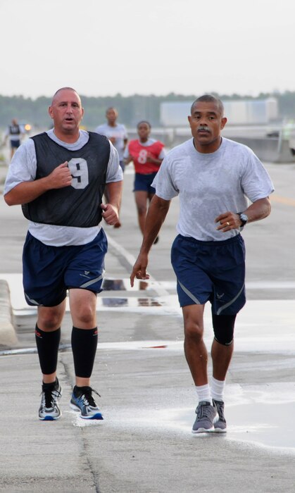 Chief Master Sgt. Mateo, 482nd Civil Engineering Squadron chief enlisted Manager, right, motivates Master Sgt. Keith Armour, 482nd CES engineering superintendent, during the run portion of his fitness assessment at Homestead Air Reserve Base, Fla., Aug. 5, 2016. The Air Force Fitness Assessment is a physical performance test used to test endurance and strength of members. (U.S. Air Force photo/Senior Airman Aja Heiden)