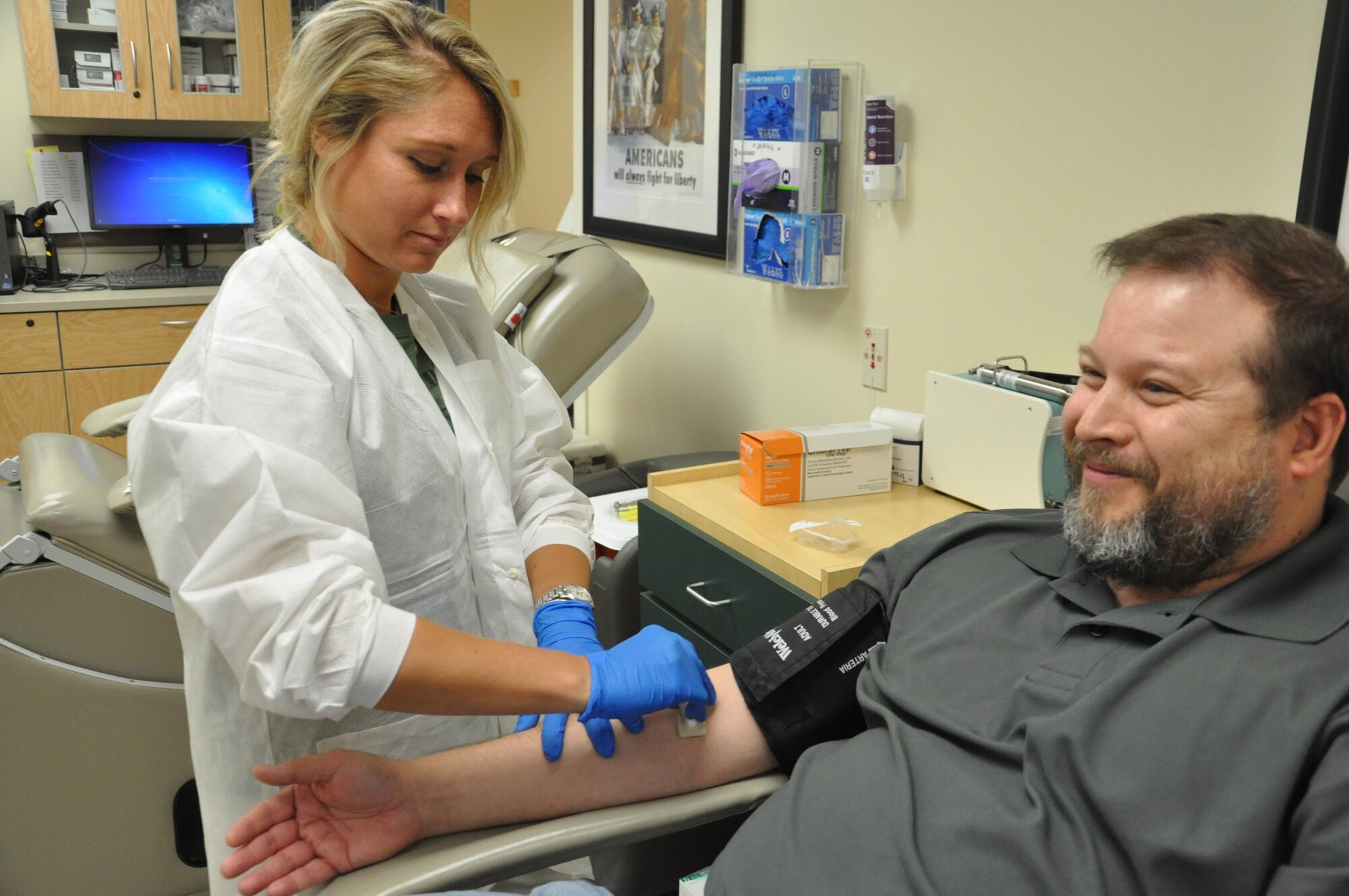 Annie Goshay, 88th Medical Group, Phlebotomist, prepares Mike Roper, a military retiree, for a blood donation in support of the Armed Services Blood Program (ASBP) at Wright-Patt. The ASBP is the official military blood program of the Department of Defense. If you are considering donating blood call the ASBP office at: 937-257-0580 or visit militaryblood.dod.mil. (U.S. Air Force photo / Bill Hancock)
 