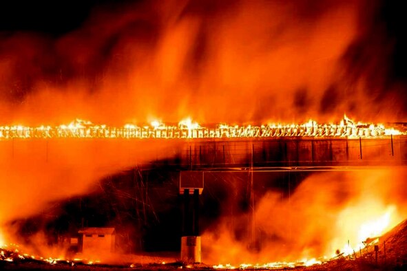 Flames consume a train bridge near Phelan, California, as the Blue Cut fire wreaks a swath of devastation recently. The fire burned more than 30,000 acres and forced the evacuation of more than 80,000 people. (Photo by Len Paris)