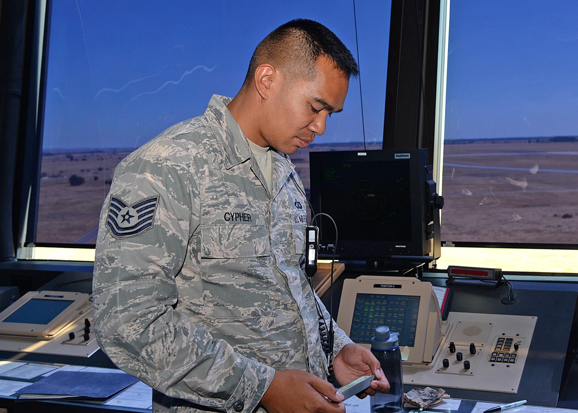 Tech. Sgt. Steven Cypher, 9th Operations Support Squadron NCO in charge of standards and evaluations, relays ground information to a pilot Aug. 31, 2016, at Beale Air Force Base, California. The information relayed ensures the pilot will be able to land safely. (U.S Air Force photo by Airman Tristan D. Viglianco)
