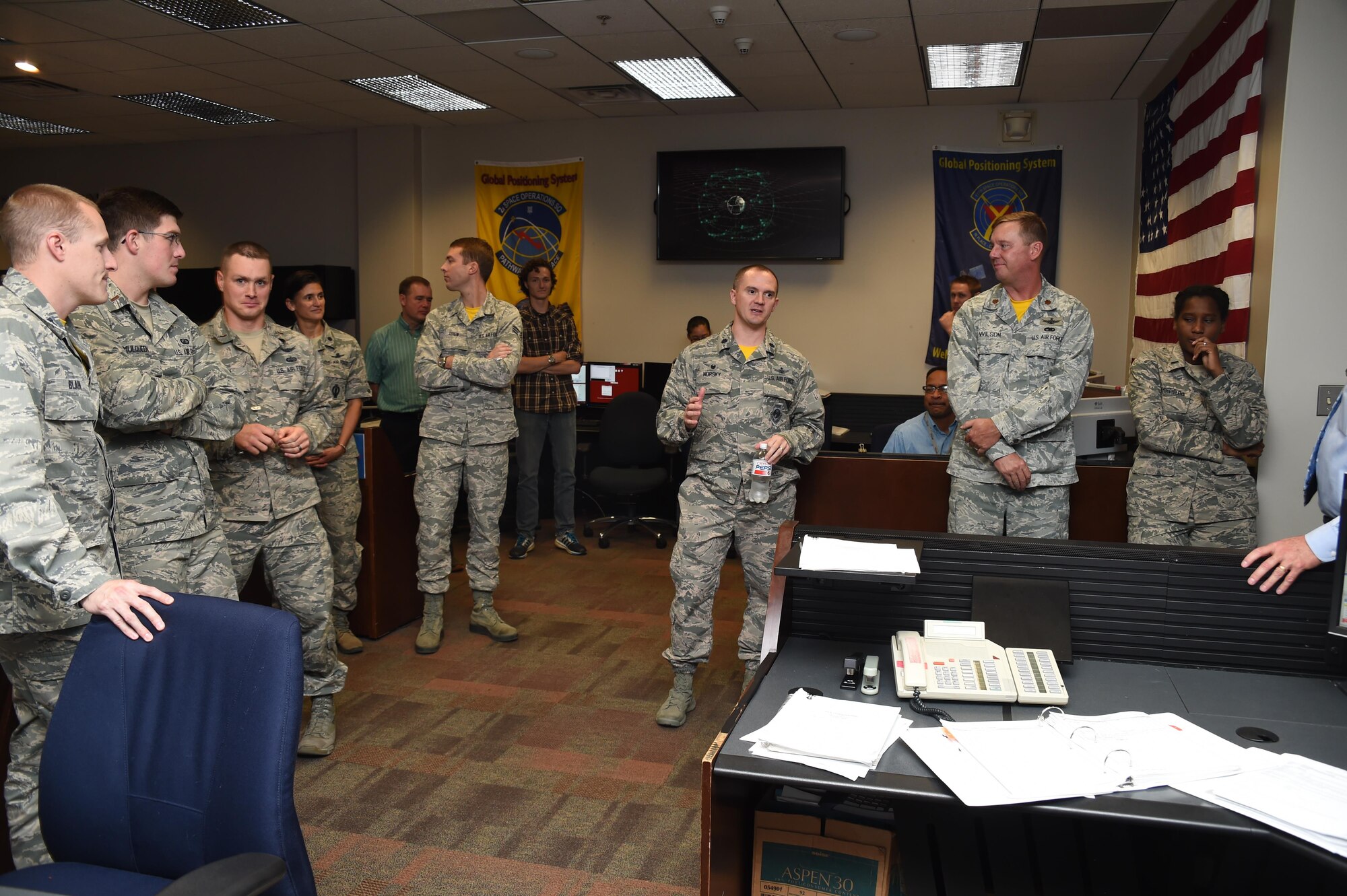 Lt. Col. Peter Norsky, 2 SOPS commander, encourages his team on the operations floor during the final command ceremony of Global Positioning System Satellite Vehicle Number 23 at Schriever Air Force Base, Colorado, Friday, Aug. 26, 2016. Norsky insisted the survival of the “bird” was because of the space operator crews who man their stations 24 hours a day, 365 days a year. (U.S. Air Force photo/2nd Lt. Darren Domingo)