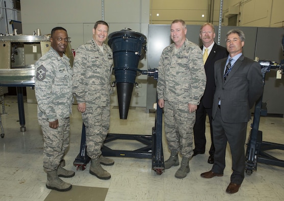 Thanks to a joint effort between the Air Force Nuclear Weapons Center and Air Force Global Strike Command, updated training simulators for MK12A reentry vehicles (pictured here at a Lockheed Martin Company’s facility) will be delivered to AFGSC. From left:  Chief Master Sgt. Calvin Williams, command chief master sergeant, AFGSC; Gen. Robin Rand, commander, AFGSC; Col. Scott Jones, director, Intercontinental Ballistic Missile Systems Directorate, AFNWC; Mr. Mathew Joyce, vice president and general manager, Strategic Missile Defense, Space System Company, Lockheed Martin Company; and Mr. Mike LeSage, Reentry Vehicle Training Simulators technician, Air Force Strategic Programs, Space Systems Company, Lockheed Martin Company.  (Courtesy photo)