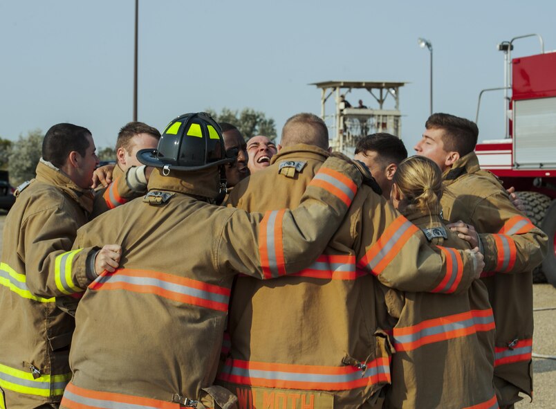 5th Civil Engineer Squadron firefighters get pumped up before training at Minot Air Force Base, N.D., Sep. 1, 2016. Along with extinguishing fires, the fire department also drives and operates fire apparatuses, specialized tools, and equipment, conducts hose evolutions and pump operations, and protects exposures, preserves and protects emergency scene evidence, and investigates fires to determine origin and cause. (U.S. Air Force photo/Airman 1st Class Christian Sullivan)