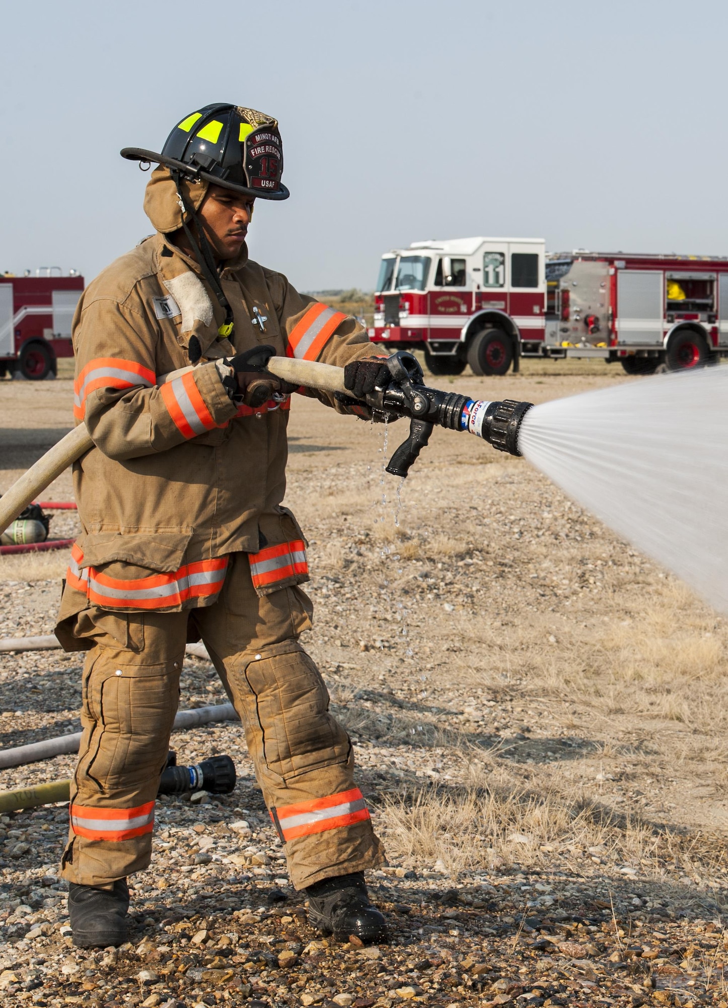 Airman 1st Class Leodanis Uceta, 5th Civil Engineer Squadron firefighter, tests the fire-hose before training at Minot Air Force Base, N.D., Sept. 1, 2016. The Minot AFB fire department train and perform exercises regularly to maintain readiness. (U.S. Air Force photo/Airman 1st Class Christian Sullivan)