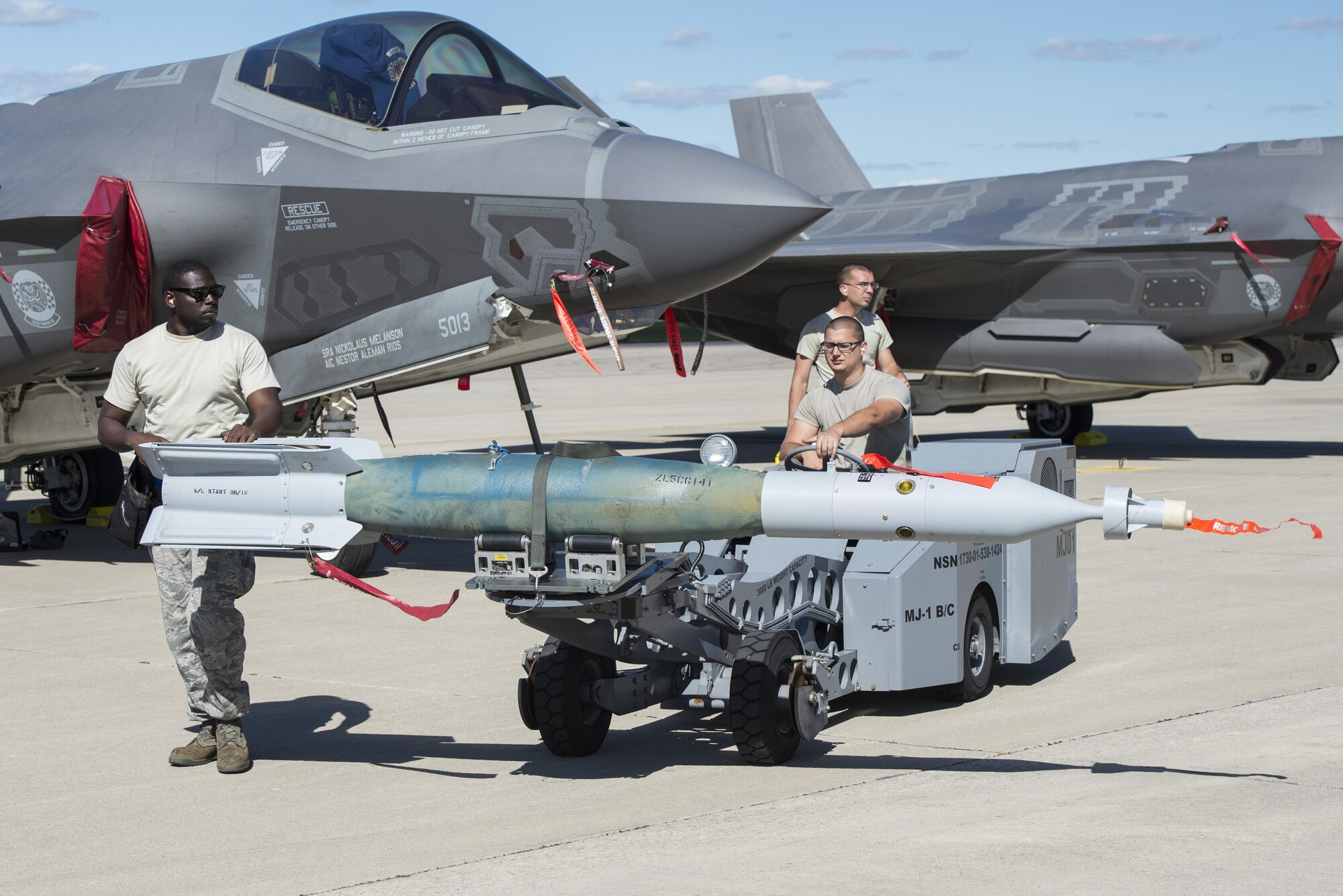 58th Aircraft Maintenance Unit weapons load crew members unload a GBU-12 from an F-35A during exercise Northern Lightning Aug. 31, 2016, at Volk Field, Wis. During the exercise, 33rd FW pilots were able to execute offensive counter air, suppression of enemy air defenses, destruction of enemy air defenses, and the employ GPS-guided munitions  for close air support. (U.S. Air Force photo by Senior Airman Stormy Archer)