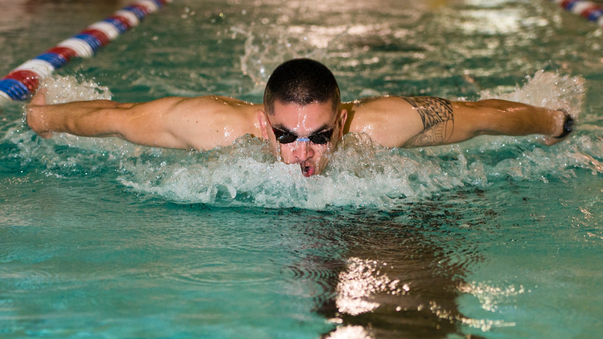 Airman 1st Class Eliezer Lizardi, 5th Munitions Squadron ammunition storage crew member, swims laps during the Summer Games at Minot Air Force Base, N.D., Aug. 30, 2016. The 4x200m freestyle relay was a new event added to the biannual games. (U.S. Air Force photo/Airman 1st Class J.T. Armstrong)