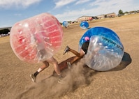 A Team Minot Airman falls while playing knockerball during the Summer Games at Minot Air Force Base, N.D., Aug. 30, 2016. In knockerball, a variation of soccer, participants wear large inflatable bubbles around their upper body that allows them to bounce off other players, and makes falling down a bit more fun. (U.S. Air Force photo/Airman 1st Class J.T. Armstrong)