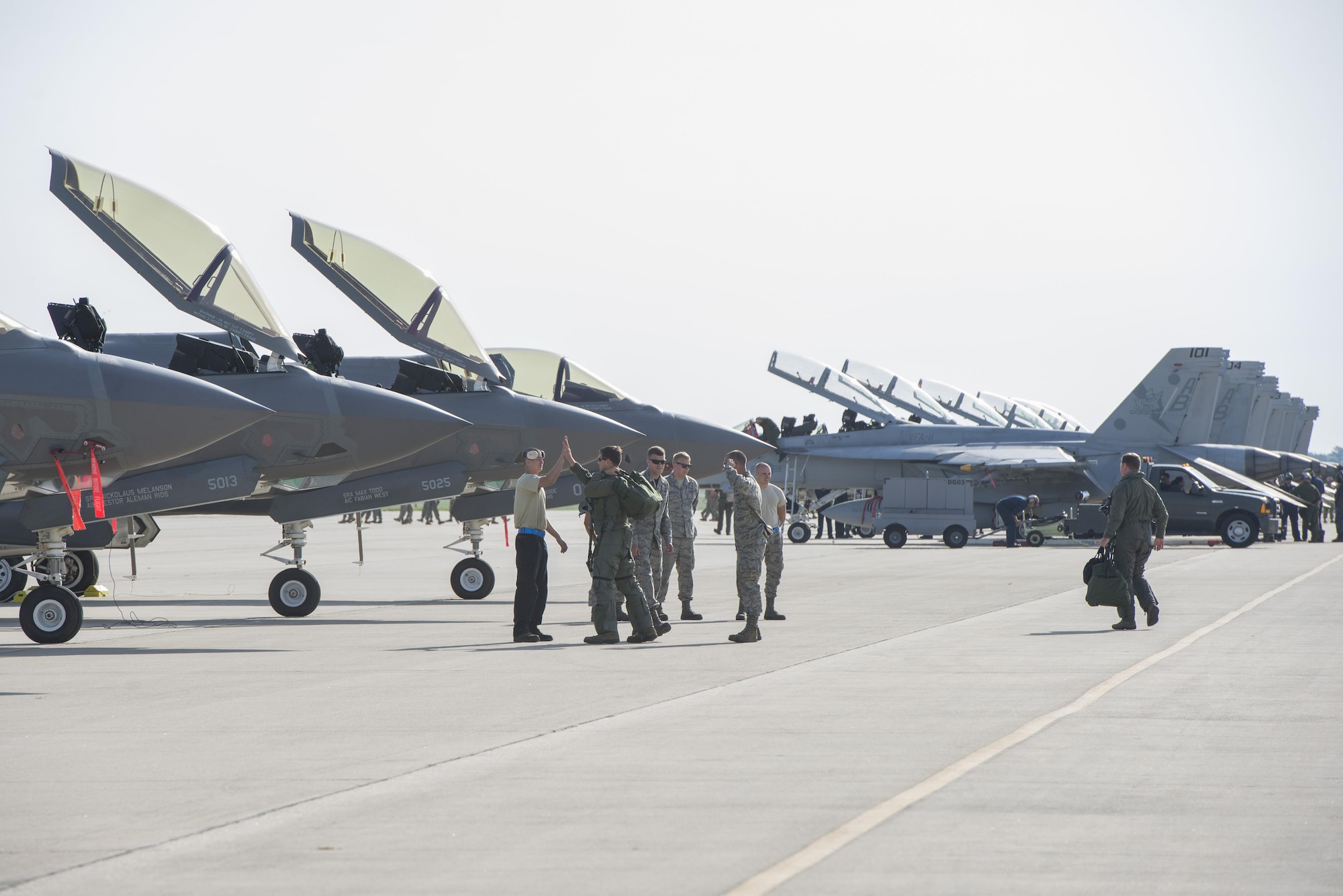 33rd Aircraft Maintenance Squadron crew chiefs greet 33rd Fighter Wing pilots as they step to their jets during exercise Northern Lightning Aug. 26, 2016, at Volk Field, Wis. Northern Lightning is a joint total force exercise between the Air National Guard, Air Force and Navy conducting offensive counter air, suppression and destruction of enemy air defense and close air support. (U.S. Air Force photo by Senior Airman Stormy Archer)