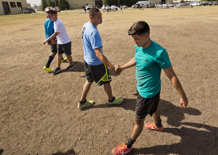 Team Minot Airmen shake hands after a game of knockerball during the Summer Games at Minot Air Force Base, N.D., Aug. 30, 2016. The Summer Games hosted new events included knockerball, build a boat and 4x200m freestyle relay. (U.S. Air Force photo/Airman 1st Class J.T. Armstrong)