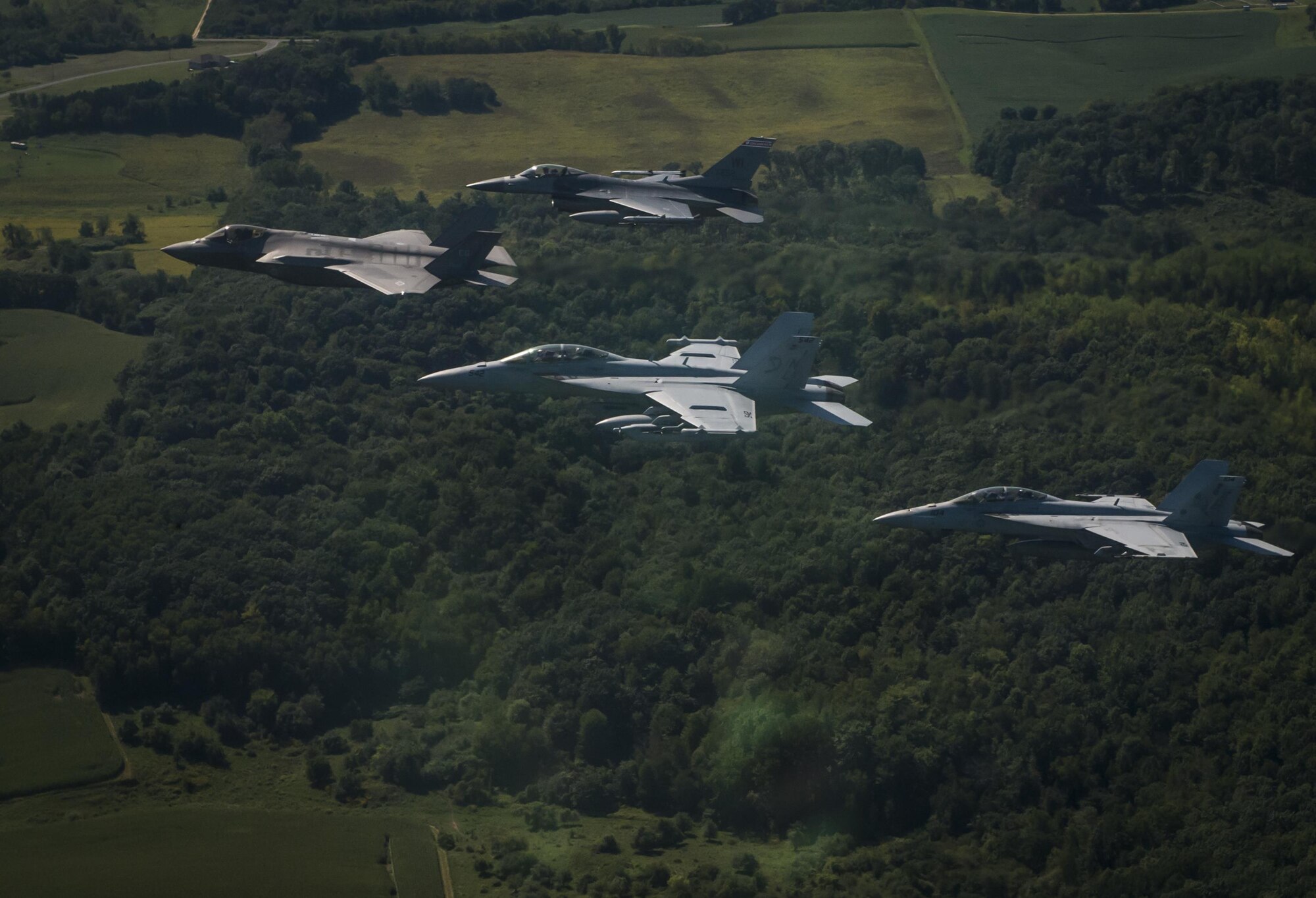 A U.S. Air Force F-35A Lighting II, F-16C Fighting Falcon and a U.S. Navy F/A-18F Super Hornet fly in formation during Exercise Northern Lighting Aug. 31, 2016. Northern Lightning is a tactical-level, joint training exercise that emphasizes fifth and fourth generation assets engaged in a contested, degraded environment. (U.S. Air Force photo/Staff Sgt. DeAndre Curtiss)
