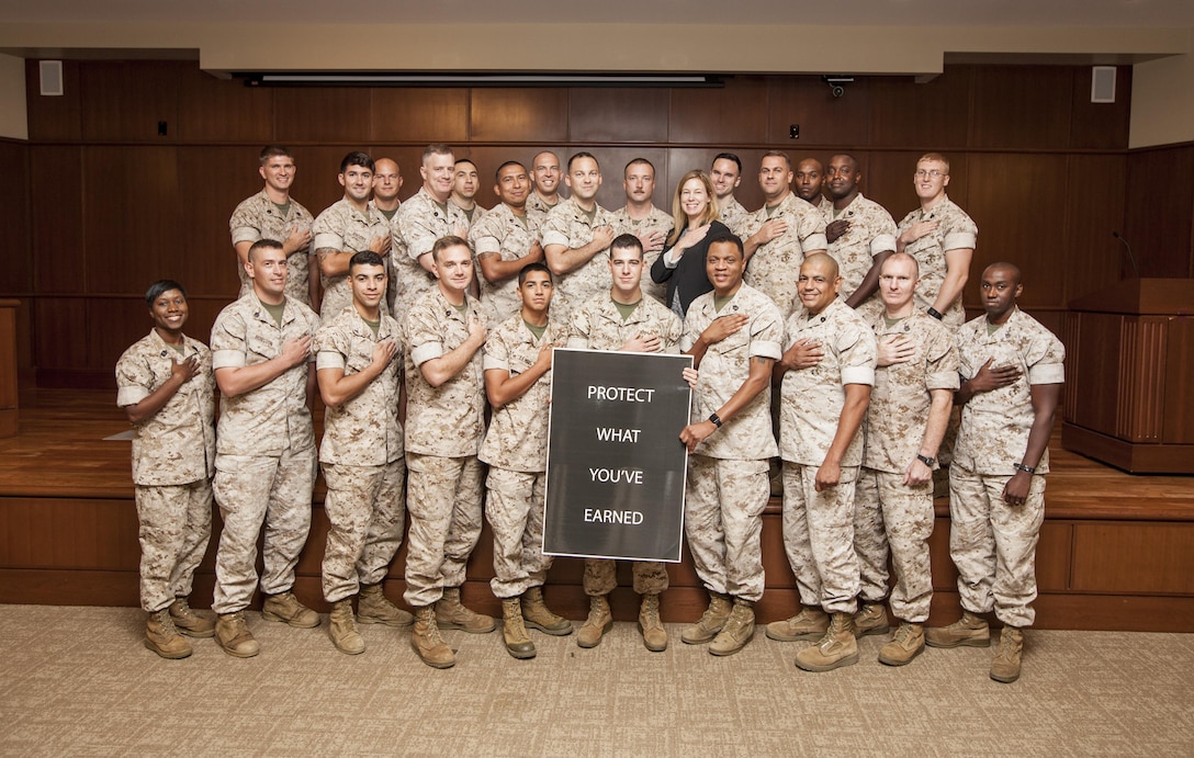 Marines with 4th Marine Logistics Group pose for a group photo at Marine Corps Support Facility New Orleans, Aug. 24, 2016. Prior to the photo, Sgt. Maj. Lanette N. Wright, sergeant major for 4th MLG, spoke to them about the "Protect What You've Earned" campaign, a Marine Corps wide initiative to promote good decision-making in all aspects of a Marine's life. While initially focused on alcohol misuse, the campaign reinforces a Marine's desire to safeguard life-long investments and hard-earned achievements through personal accountability. (U.S. Marine Corps photo by Lance Cpl. Ricardo Davila/Released)