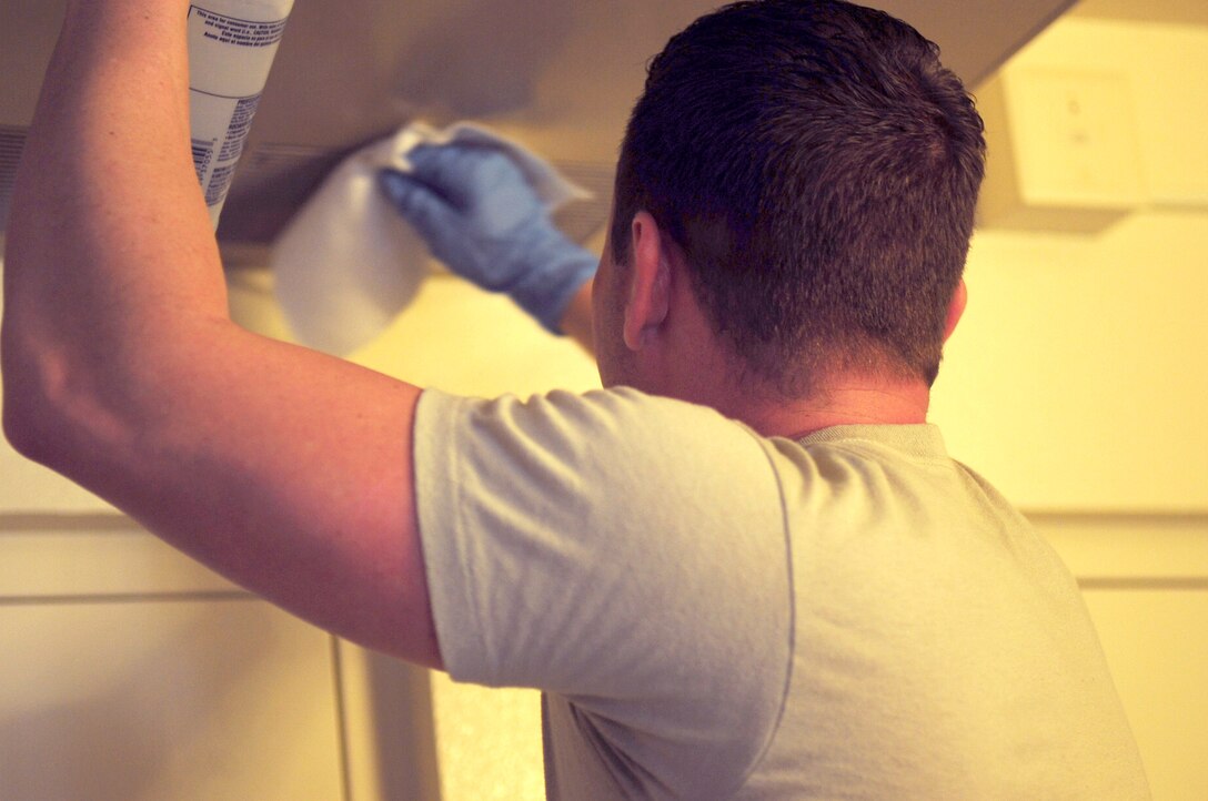 U.S. Air Force Tech. Sgt. Brian Bollhoefer, 7th Civil Engineer Squadron central dorm management office Airman dormitory leader, cleans mildew and slight mold off an Airman’s air-conditioner unit Aug. 22, 2016, at Dyess Air Force Base, Texas. Airmen dorm leaders complete about 1,600 work orders a year. (U.S. Air Force photo by Airman 1st Class April Lancto/Released)

