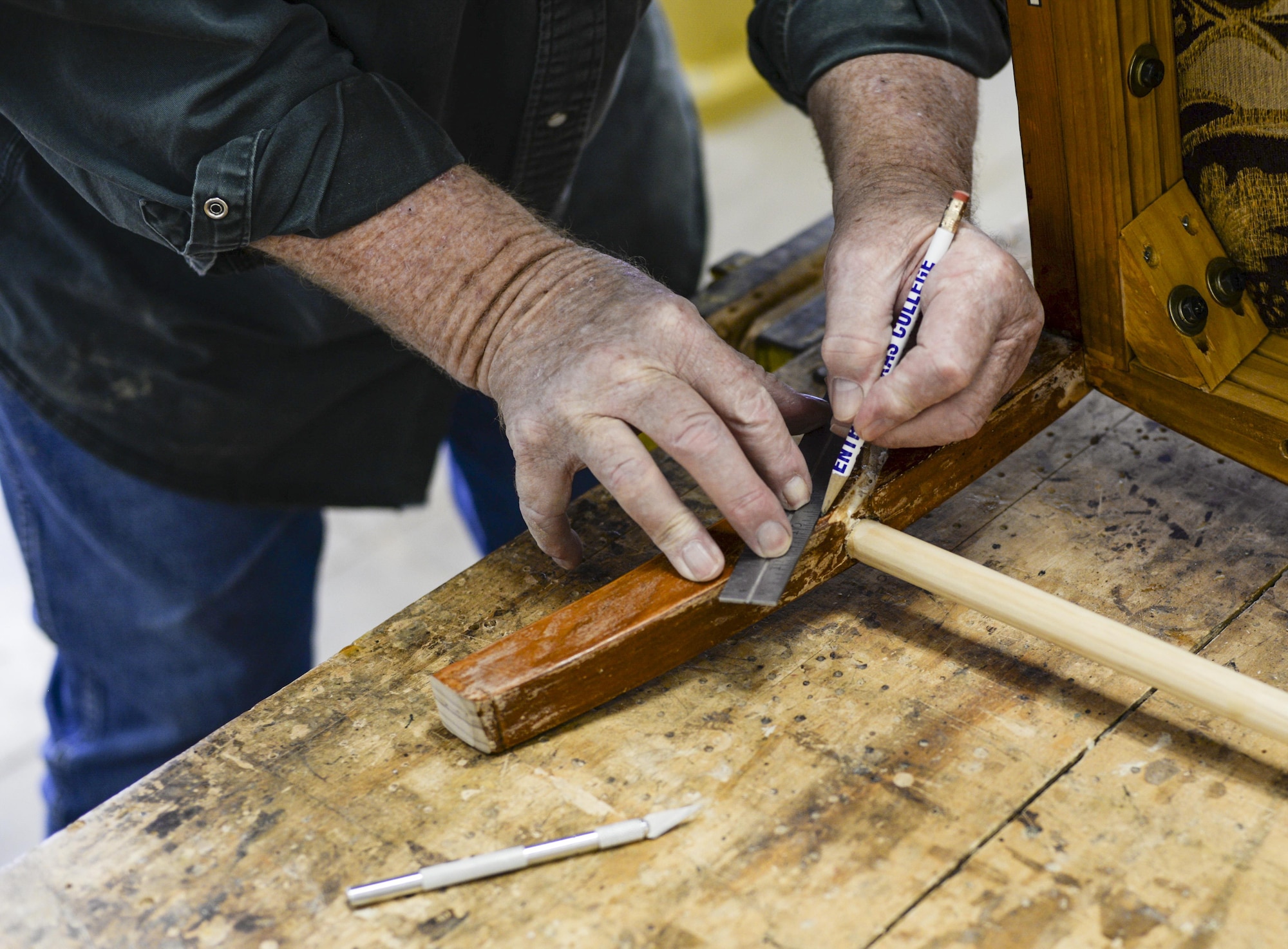 Joe, the 49th Force Support Squadron Wood Shop supervisor, repairs a broken chair at Holloman Air Force Base, N.M. 11 Aug. 2016. Airmen and civilians, age 18 and up, can pay $30 to obtain their Wood Shop certification. (Last names are being withheld due to operational requirements. U.S. Air Force photo by Airman Alexis P. Docherty) 