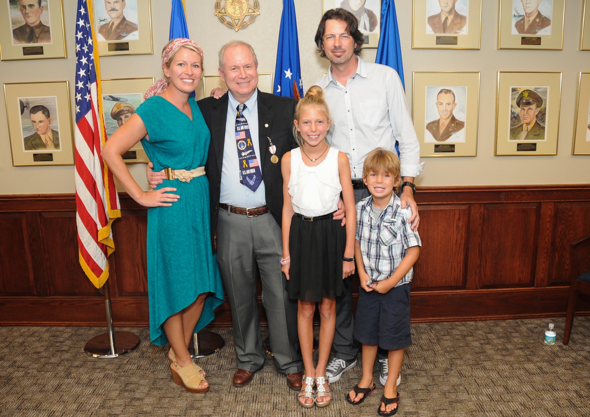 Family stands with Ed Wempe during his retirement ceremony at Barksdale AFB, La., Aug. 18, 2016. Wempe received the Outstanding Civilian Career Service Award and retired as the Eighth Air Force Intelligence Directorate and 608th Air Operations Center technical director. (U.S. Air Force photo by Amn Alexis Schultz)