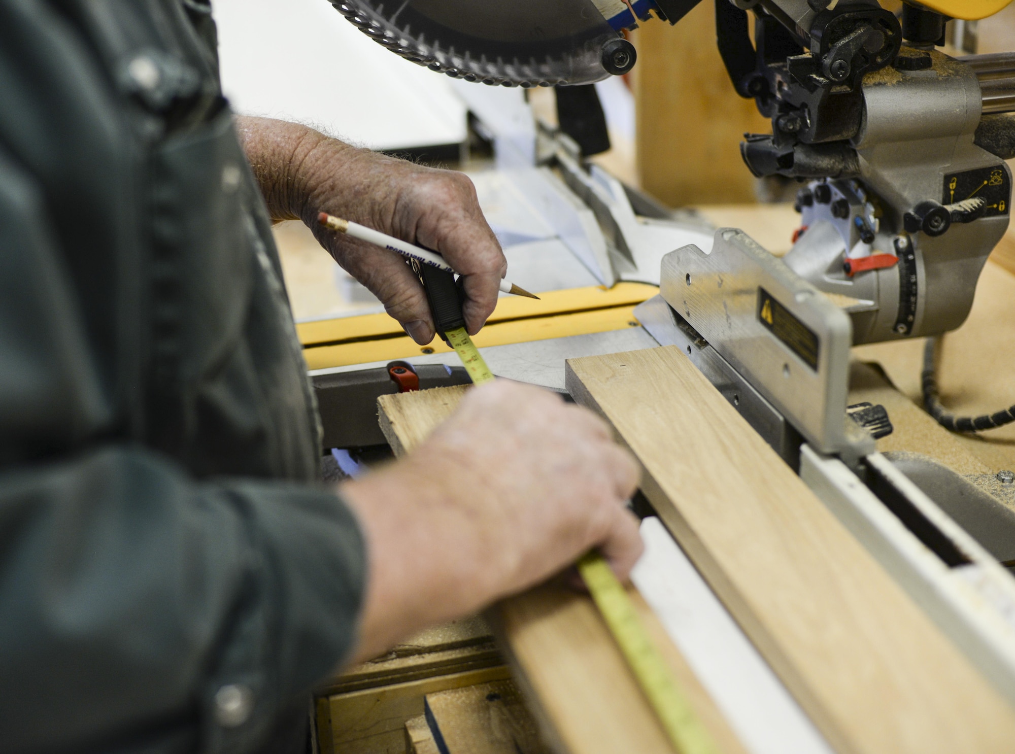 Joe, the 49th Force Support Squadron Wood Shop supervisor, measures a board of redwood at Holloman Air Force Base, N.M. 23 Aug. 2016. Airmen and civilians can utilize the shop’s premium woodworking equipment to work on personal projects. (Last names are being withheld due to operational requirements. U.S. Air Force photo by Airman Alexis P. Docherty) 