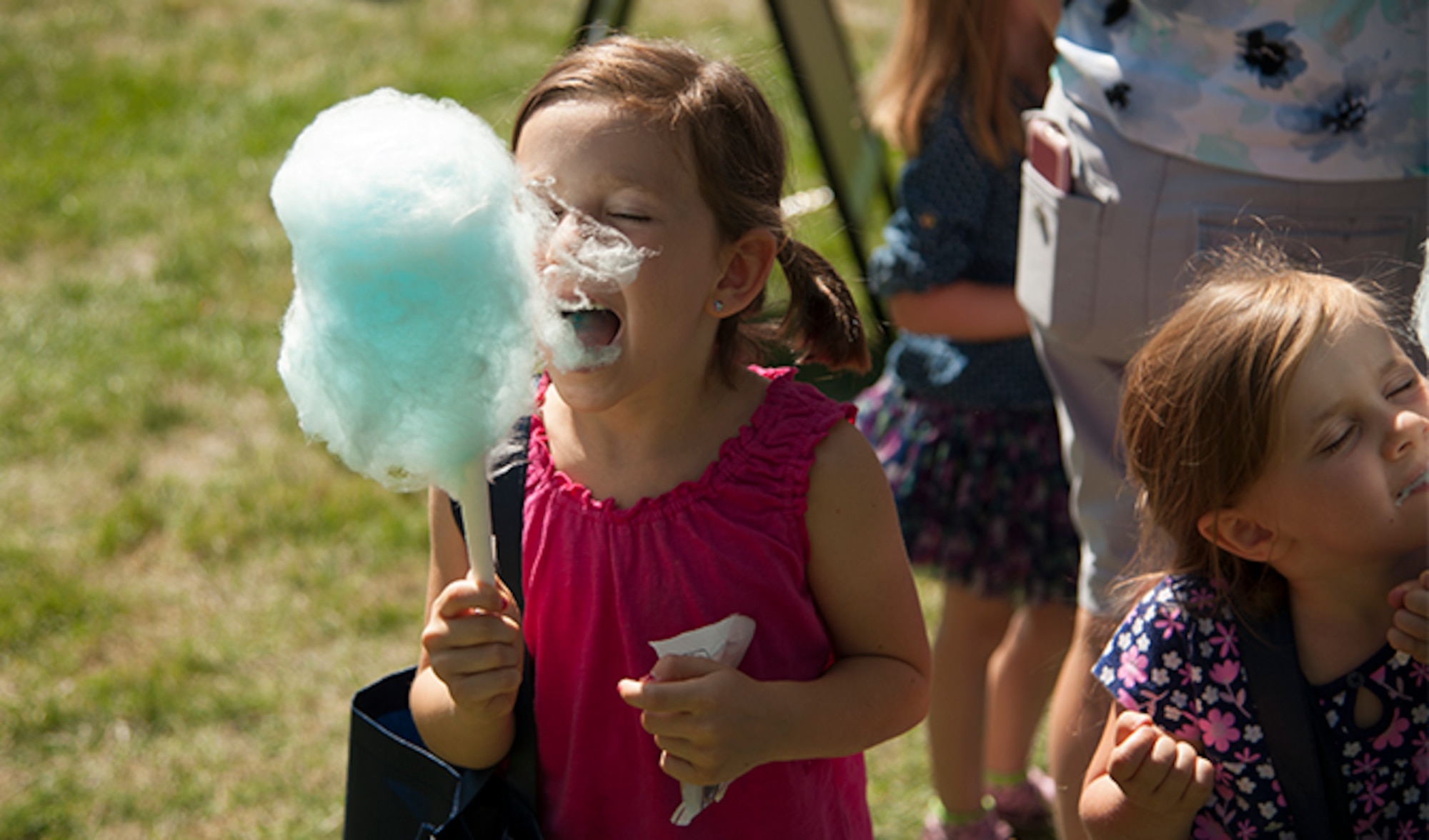 Emily Liapis partakes of some freshly made cotton candy during the Food Truck Festival, Aug. 26, 2016, at Fairchild Air Force Base, Wash. The Food Truck Festival offered many treats and games for children big and small. 
(U.S. Air Force photo/Airman 1st Class Ryan Lackey)
