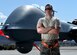 A crew chief assigned to the 432nd Aircraft Maintenance Squadron Tiger Aircraft Maintenance Unit poses for a photo in front of an MQ-9 Reaper Aug. 24, 2016, at Creech Air Force Base, Nevada.  The first MQ-9 launch from Tiger Aircraft Maintenance Unit signals the start of the transition to an all MQ-9 force. (U.S. Air force photo by Airman 1st Class James Thompson)