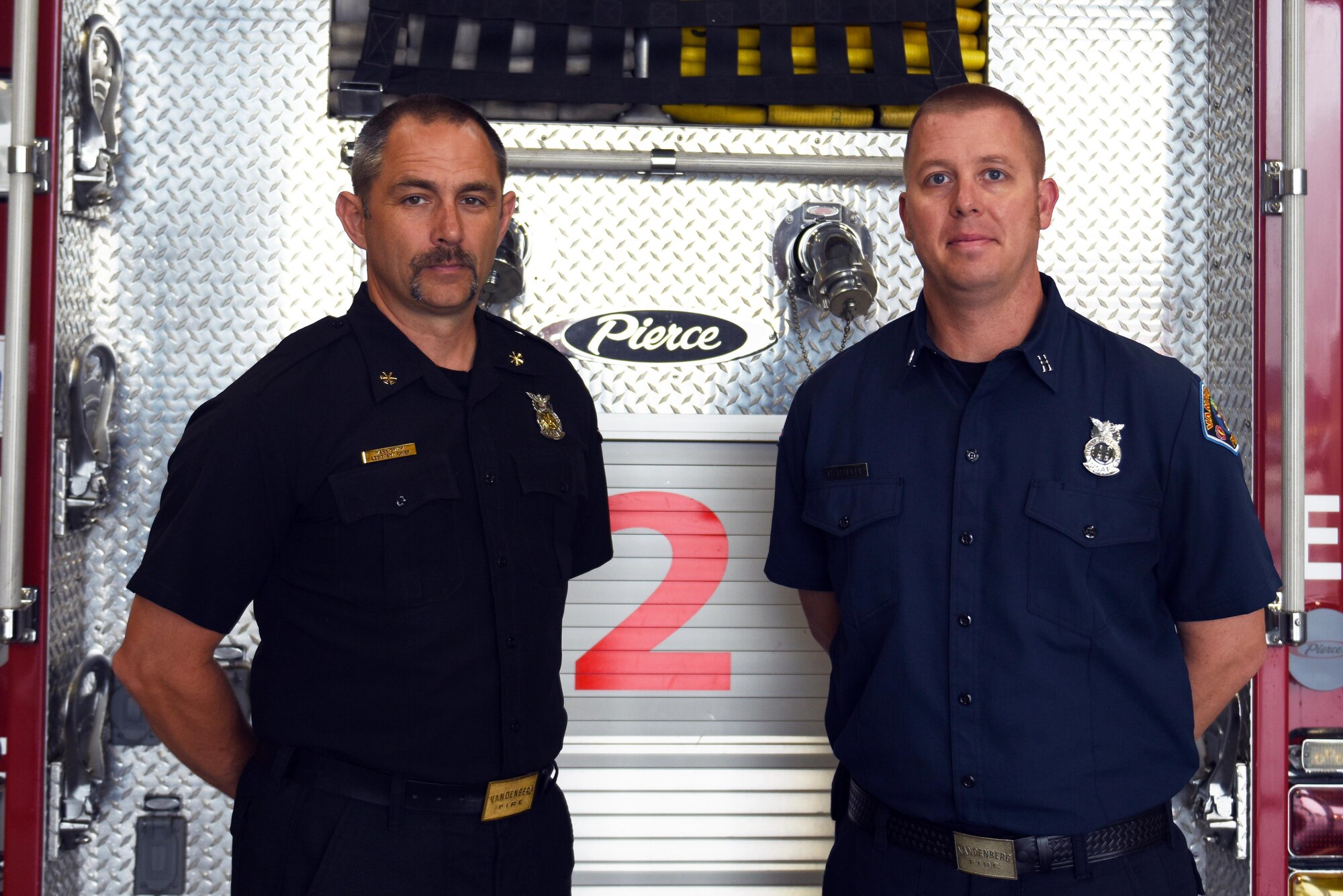 Mark Smith, 30th Civil Engineer Squadron assistant chief of operations, and Robert Raffel, 30th CES rescue truck captain, Sept. 1, 2016, Vandenberg Air Force Base, Calif. Smith and Raffel, won DoD civilian fire officer of the year and DoD civilian firefighter of the year, respectively. (U.S. Air Force photo by Senior Airman Ian Dudley/Released)