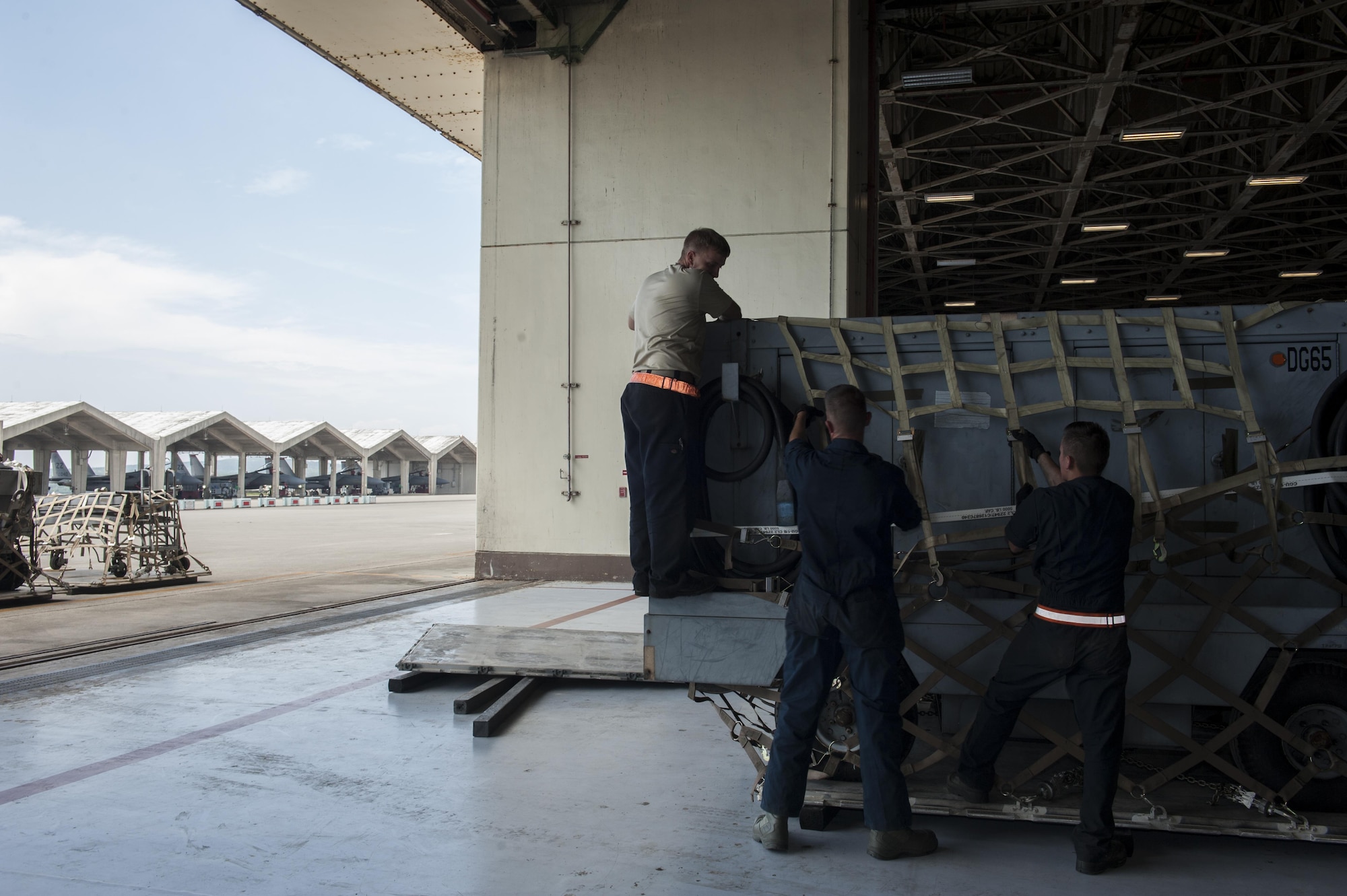 Airmen from the 18th Equipment Maintenance Squadron prepare a Trilectron generator for loading Aug. 31, 2016, at Kadena Air Base, Japan. The Trilectron generator can provide power to an aircraft as maintenance is being performed on it. One generator is worth $257,000. (U.S. Air Force photo by Airman 1st Class Lynette M. Rolen)