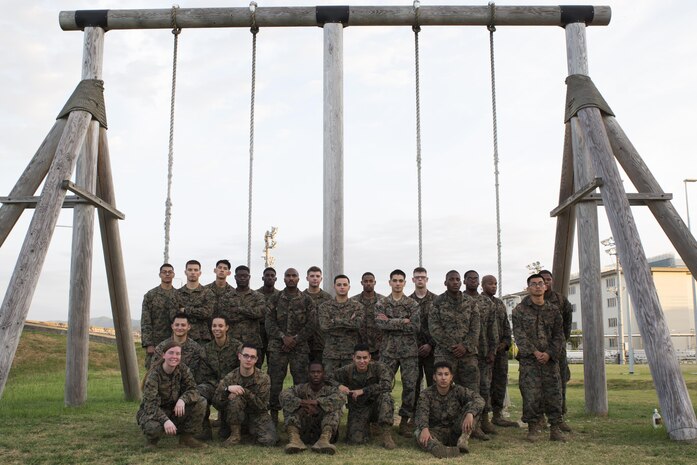 U.S. Marines with Marine Aircraft Group 12 Headquarters pose for a photo after running the obstacle course at Marine Corps Air Station Iwakuni, Japan, Aug. 26, 2016. Marines ran the obstacle course as part of a physical training exercise where they had to work together in getting a bowl of water through the course. (U.S. Marine Corps photo by Lance Cpl. Abrego) 