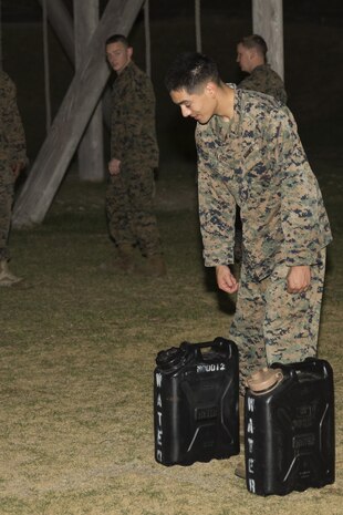 Cpl. Javier Flores, embark noncommissioned officer with Marine Aircraft Group 12, prepares to run the obstacle course with containers of water at Marine Corps Air Station Iwakuni, Japan, Aug. 26, 2016. Marines with MAG-12 were tasked with working as a team to get water through the obstacle course in simulation of problems they have to have to maneuver around.  (U.S. Marine Corps photo by Lance Cpl. Abrego) 