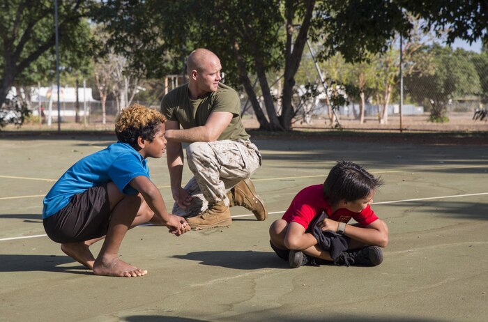 U.S. Marine Corps Cpl. Landis Lied, an embarkation and logistics specialist assigned to Marine Fighter Attack Squadron (VMFA) 122, plays Red Red Bob, a version of the game “tag”, with students at MacFarlane Primary School Katherine, Northern Territory, Australia, Sept.1, 2016. Invited by the school every iteration of Southern Frontier, a three week unit level training conducted by U.S. Marines  at Royal Australian Air Force Base Tindal, Marines mentor, teach and provide role models to the students. With a student population of 92 percent indigenous, students are provided a consolidated education in literacy, numeracy, respect and behavior management. (U.S. Marine Corps photo by Cpl. Nicole Zurbrugg) 