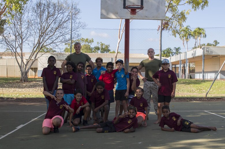 U.S. Marine Corps Cpl. Cody Braunscheidel, left, an aviation logistics information management systems specialist, and Cpl. Landis Lied, right, an embarkation and logistics specialist assigned to Marine Fighter Attack Squadron (VMFA) 122, pose with students from MacFarlane Primary School in Katherine, Northern Territory, Australia, Sept. 1, 2016. Marines are invited to mentor, teach and serve as role models to the students every iteration of Southern Frontier, a three week unit level training conducted by U.S. Marines at Royal Australian Air Force Base Tindal. With a population of 92 percent indigenous students, the school provides a structured educational environment to the students. (U.S. Marine Corps photo by Cpl. Nicole Zurbrugg) 