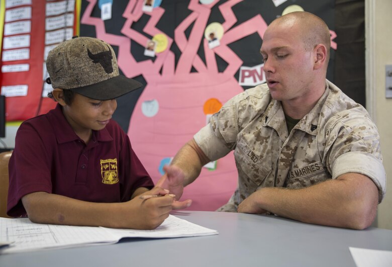 U.S. Marine Corps Cpl. Landis Lied, an embarkation and logistics specialist assigned to Marine Fighter Attack Squadron (VMFA) 122, helps a student with multiplication at MacFarlane Primary School in Katherine, Northern Territory, Australia, Sept. 1, 2016. Marines are invited to mentor and teach students every iteration of Southern Frontier, a three week unit level training conducted by U.S. Marines at Royal Australian Air Force Base Tindal. The primary school’s student population is 92 percent indigenous and is very transient. Classes are designed to provide students structure and a consolidated education in literacy, numeracy, respect and behavior management. (U.S. Marine Corps photo by Cpl. Nicole Zurbrugg) 