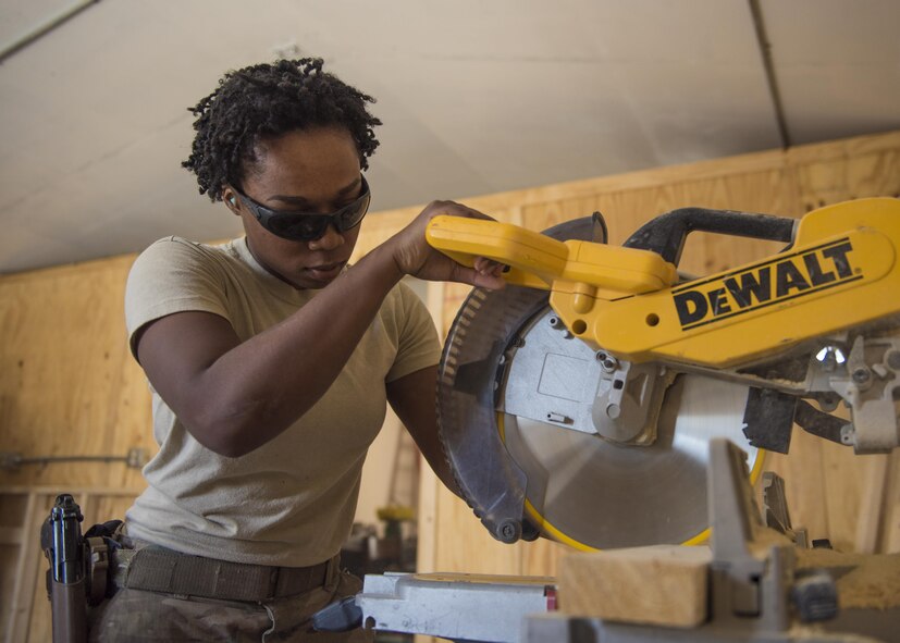 Airman 1st Class Taylor Davis, 455th Expeditionary Civil Engineer Squadron structural journeyman, cuts scrap wood with a table saw, Bagram Airfield, Afghanistan, Aug. 31, 2016. The structures team built shelving units for a new Airman’s Ministry Center and Airman’s Attic. (U.S. Air Force photo by Senior Airman Justyn M. Freeman)