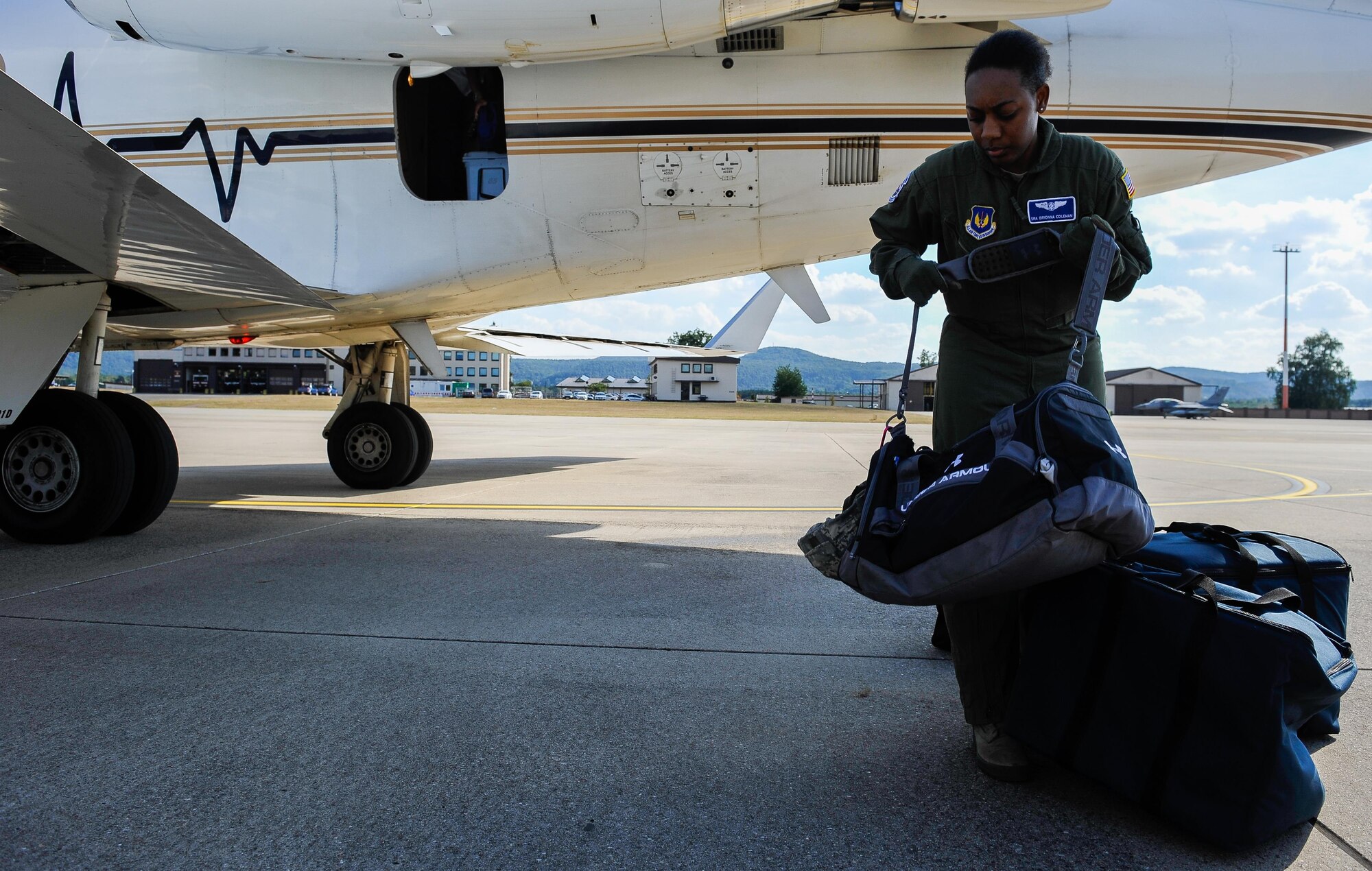 Senior Airman Brionna Coleman, 86th Aeromedical Evacuation Squadron mission launch aeromedical evacuation technician, transports bags between a Gulfstream III and an ambulance during an aeromedical evacuation mission Sept. 1, 2016, at Ramstein Air Base, Germany. Providing essential care in multiple medical roles, Aerospace Medical Service specialists assist doctors and care for patients in a wide range of situations. (U.S. Air Force photo/Airman 1st Class Lane T. Plummer)