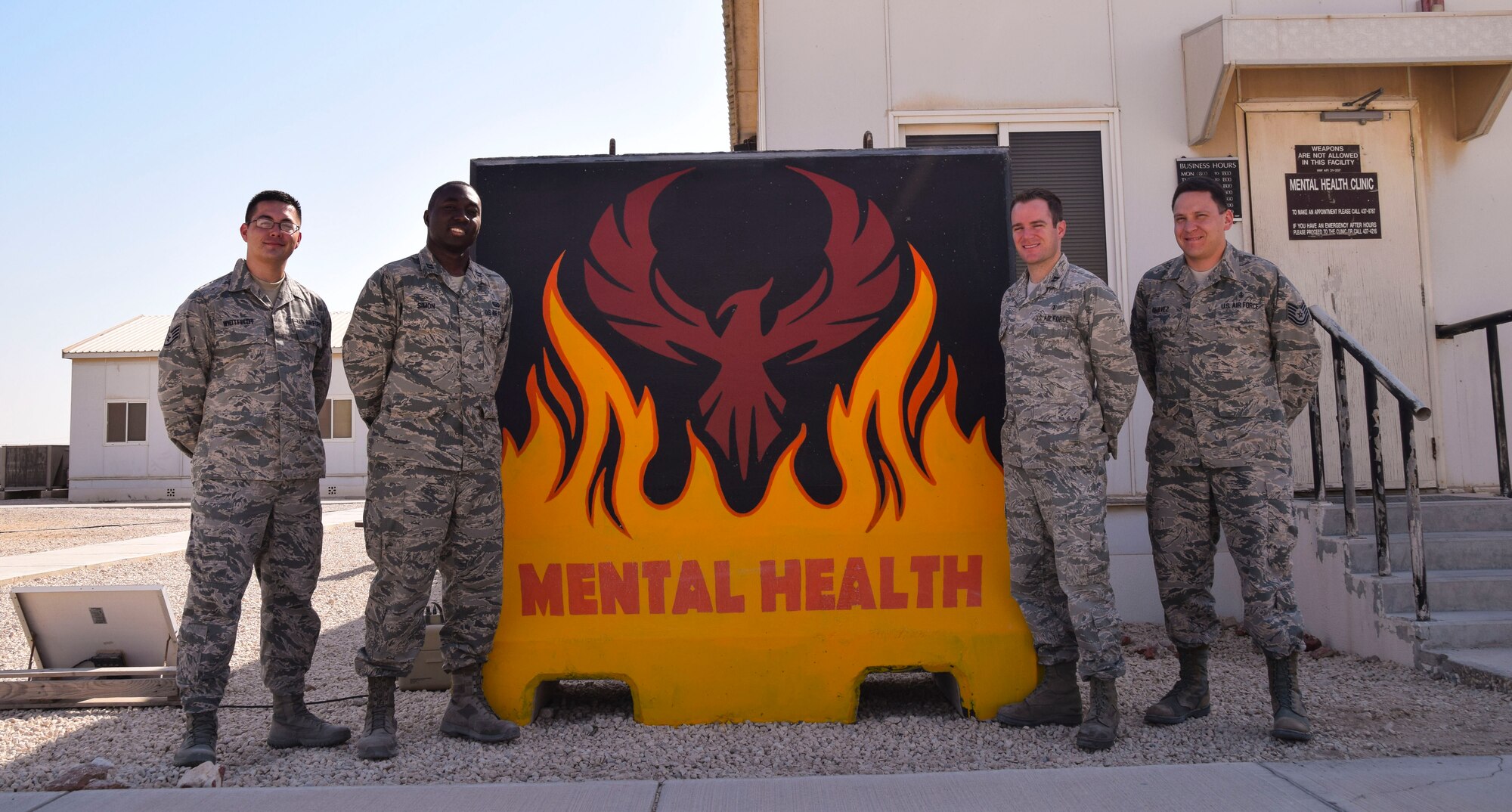 The four Airmen of the 379th Expeditionary Medical Operations Squadron mental health clinic from left to right,  Staff Sgt. Nickolas Widtfeldt, mental health technician, Capt. Tyrone Simon, social worker,  Capt.  (Dr.) Ryan Dumke, psycholigist, Technical Sgt. Anthony Chavez, mental health technician, assemble for a team photo  Aug. 26, 2016, at Al Udeid Air Base, Qatar. (U.S. Air Force photo/Tech. Sgt. Carlos J. Trevino/Released)