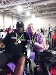 Kathy Tilbury poses with Duke Roscoe, a retired Marine from Atlanta, Georgia. Both received gold medals after competing in handle ball during the National Veterans’ Wheelchair Games June 26 – July 2, 2016 in Salt Lake City, Utah. Tilbury is a retired Navy Petty Officer 2nd Class working for Defense Logistics Agency’s Office of Operations Resource and Research Analysis on Defense Supply Center Richmond, Virginia. 