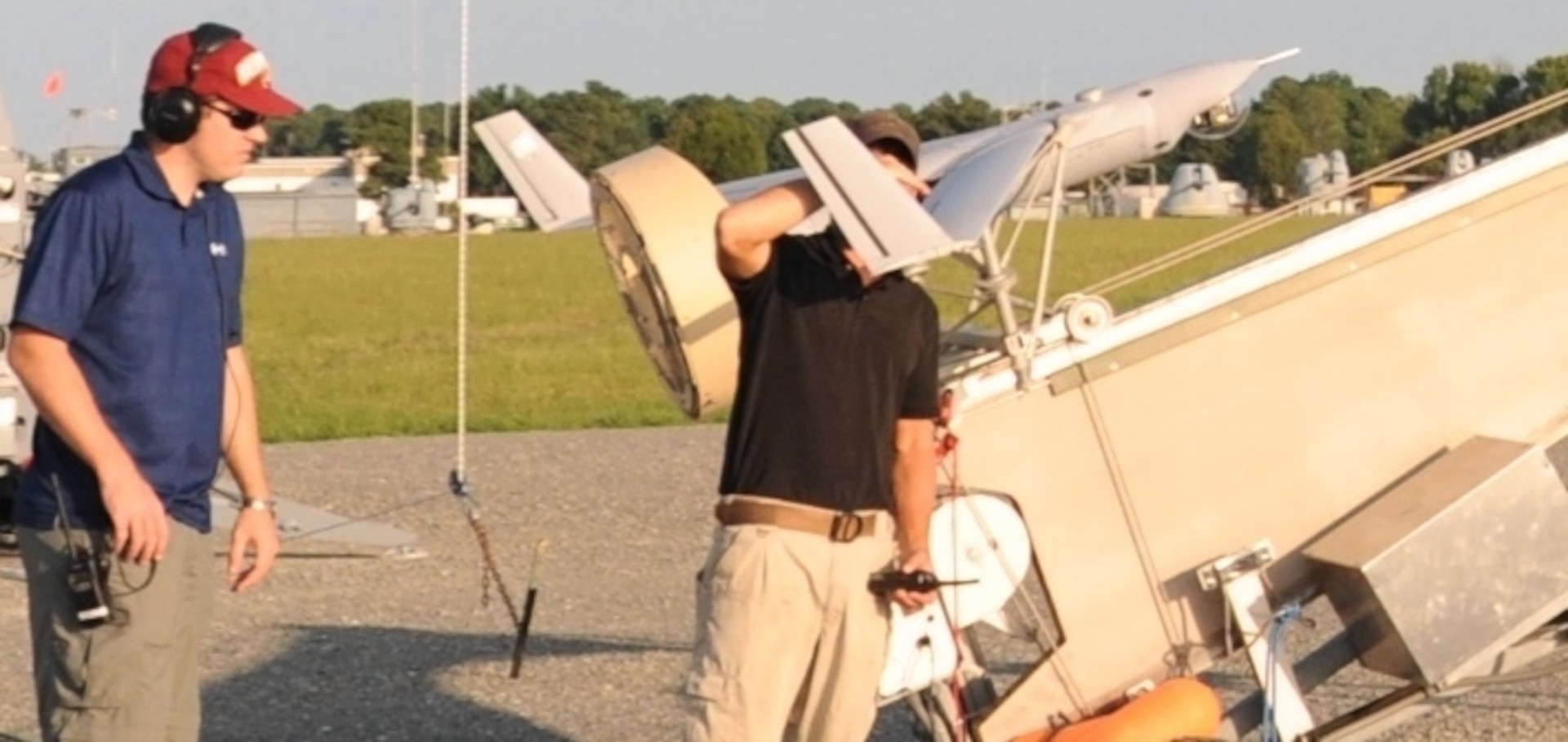 DAHLGREN, Va. - Navy engineers Jonathan Elliott and Richard Lay conduct pre-launch check-outs of a Scan Eagle unmanned aerial vehicle (UAV) at the Naval Surface Warfare Center Dahlgren Division Potomac River Test Range, Aug. 30. The Scan Eagle was crucial to the Navy's evaluation of a strike group's gun weapon systems, combat systems, and unmanned vehicles integrated with surface and air assets at the 2016 USS Dahlgren demonstration. The cybernetic USS Dahlgren proved engagement coordination across the simulated battlegroup and live fire destruction of multiple targets from two combatants utilizing two different gun based systems. 