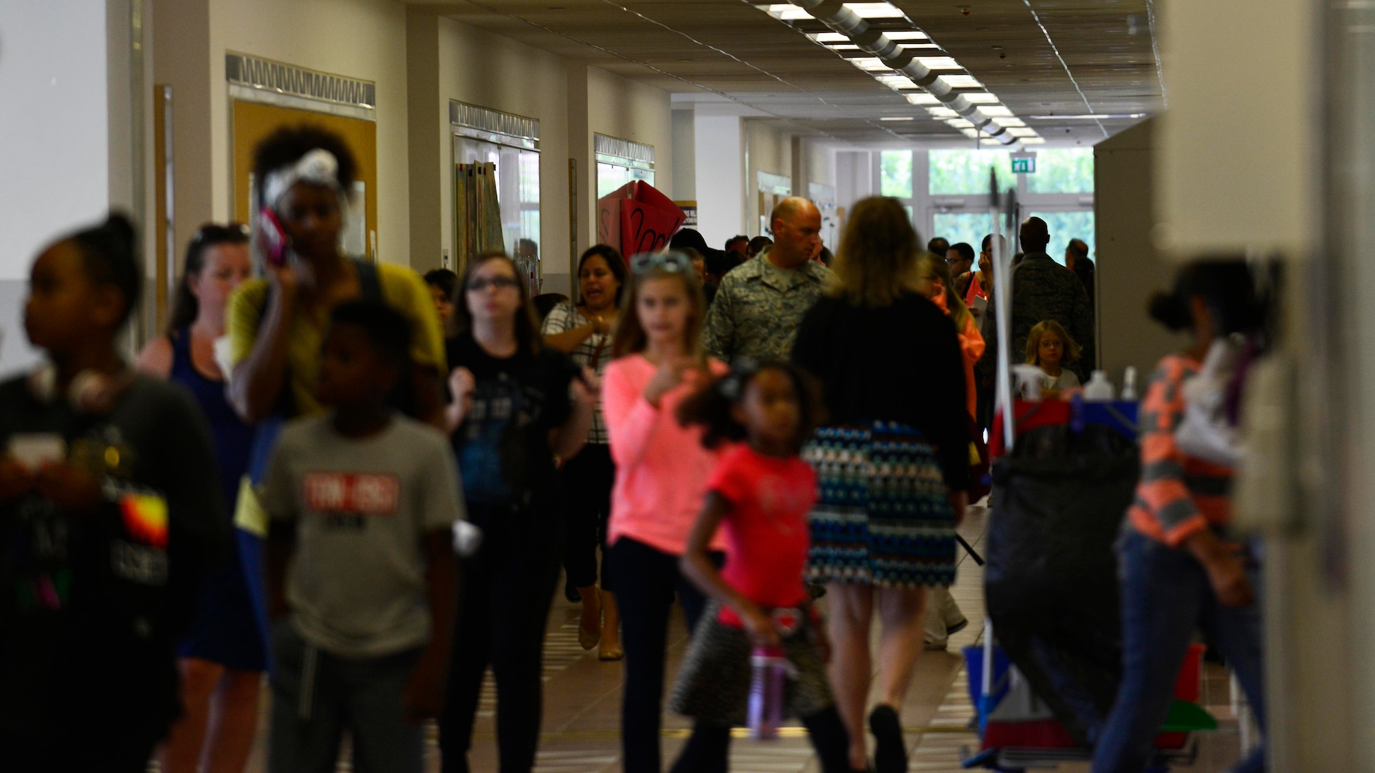Parents and their children walk the halls of Aviano Middle-High School during the Aviano back-to-school open house at Aviano Air Base, Italy, Sept. 1, 2016. Parents had the opportunity to meet their children’s teachers and gain a better understanding of the class curriculum. (U.S. Air Force photo by Airman 1st Class Cary Smith/Released)