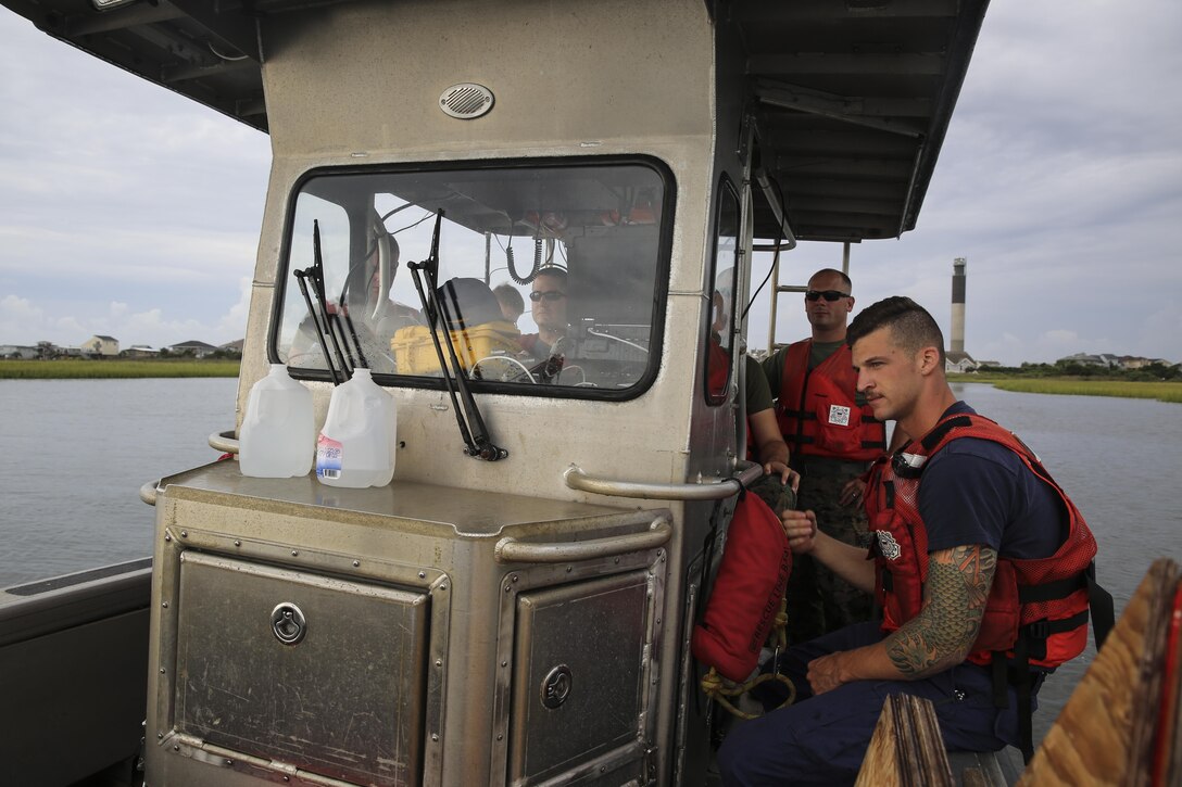 U.S. Marines with Battlefield Surveillance Company, 2nd Intelligence Battalion, and U.S. Coast Guardsmen boat through channels and survey the water off the coast of Oak Island, N.C., Aug. 31, 2016. The Marines teamed up with U.S. Coast Guardsmen at USCG Station Oak Island, N.C., to create a topographical layout of waterways that were previously unidentifiable. The new maps will correct navigation discrepancies such as off-station buoys or extinguished lights. (U.S. Marine Corps photo by Cpl. Kaitlyn V. Klein)