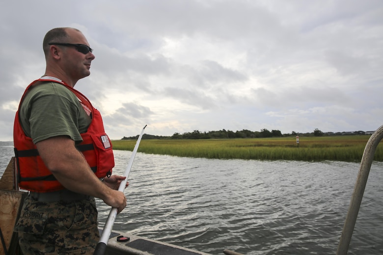 Staff Sgt. Daniel Weybright, a geographic intelligence specialist with Battlefield Surveillance Company, 2nd Intelligence Battalion, prepares to test the depth of the water off the coast of Oak Island, N.C., Aug. 31, 2016. U.S. Marines with the battalion teamed up with U.S. Coast Guardsmen at USCG Station Oak Island, N.C., to create a topographical layout of waterways that were previously unidentifiable. The new maps will correct navigation discrepancies such as off-station buoys or extinguished lights. (U.S. Marine Corps photo by Cpl. Kaitlyn V. Klein)