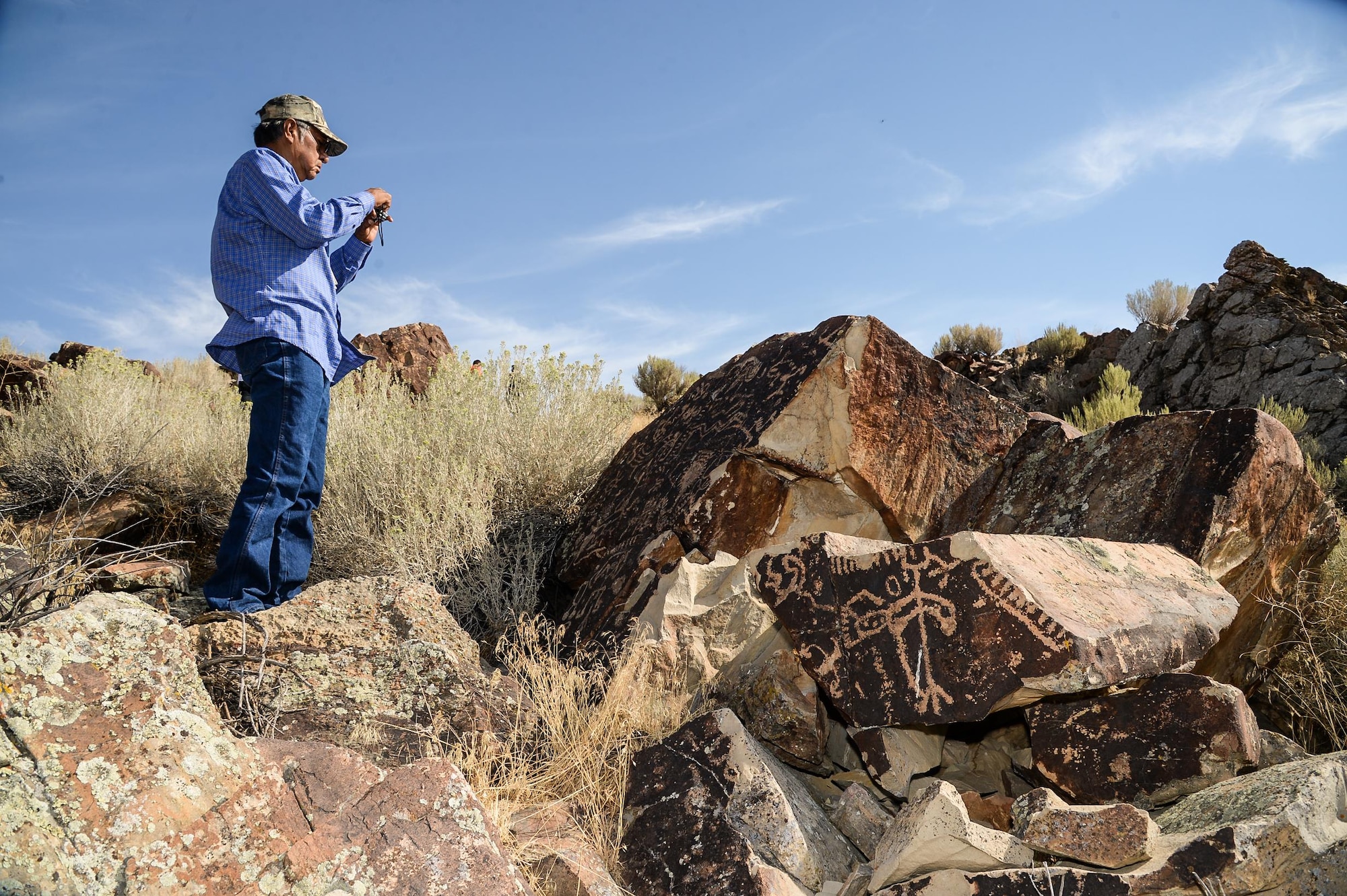 Rupert Steele of the Confederated Tribes of the Goshute Reservation takes a photo during a tour of a petroglyph site in Box Elder County, Utah, Aug. 26, 2016. The tour was part of the 2016 Annual American Indian Meeting, an event which provides a face-to-face forum for tribal leaders and federal agencies to discuss tribal concerns on federally managed land. (U.S. Air Force photo by R. Nial Bradshaw)