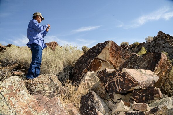 Rupert Steele of the Confederated Tribes of the Goshute Reservation takes a photo during a tour of a petroglyph site in Box Elder County, Utah, Aug. 26, 2016. The tour was part of the 2016 Annual American Indian Meeting, an event which provides a face-to-face forum for tribal leaders and federal agencies to discuss tribal concerns on federally managed land. (U.S. Air Force photo by R. Nial Bradshaw)