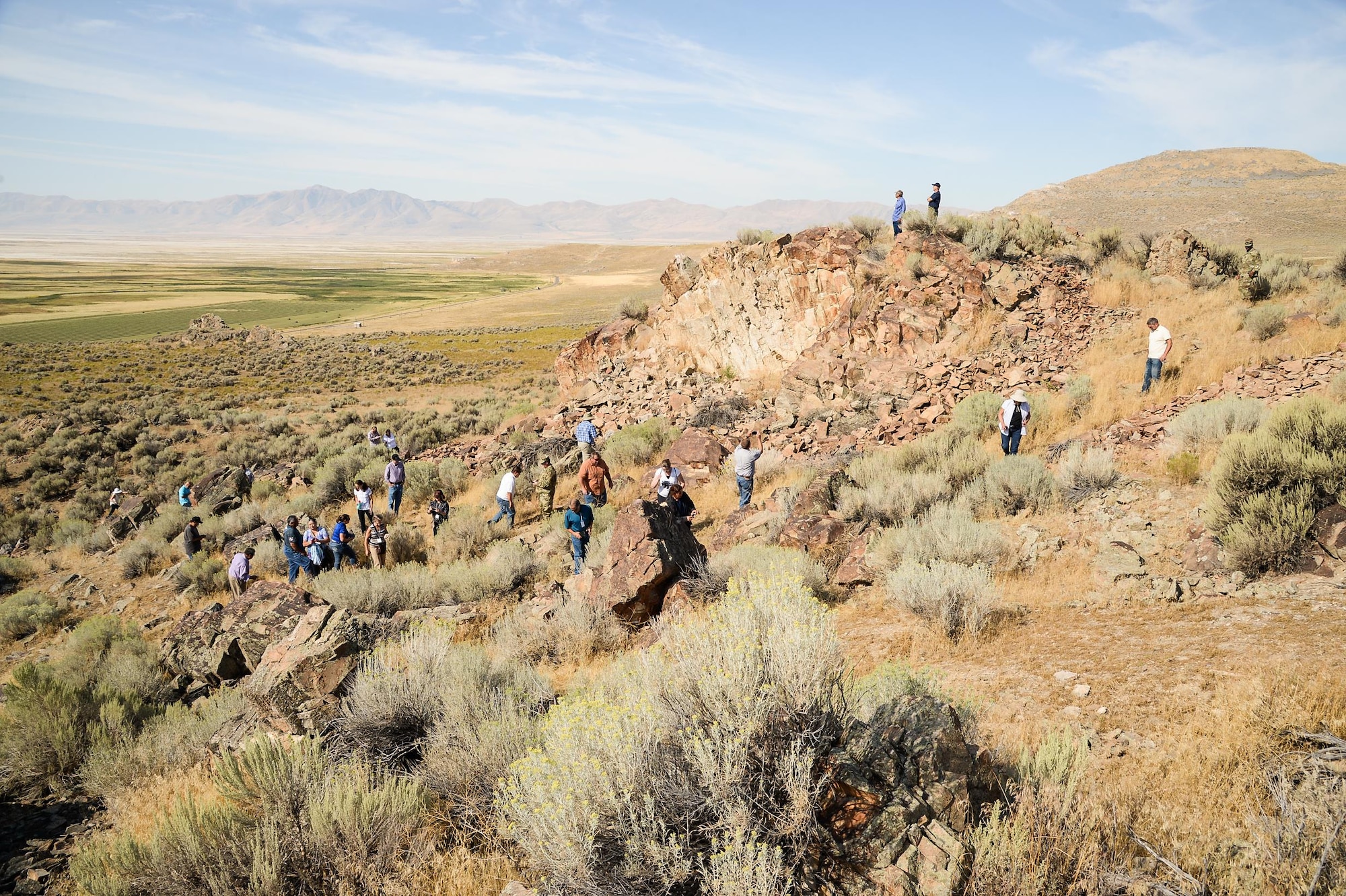 Attendees of the 2016 Annual American Indian Meeting climb a hillside in Box Elder County, Utah, during a guided tour of a petroglyph site, Aug. 26, 2016. (U.S. Air Force photo by R. Nial Bradshaw)
