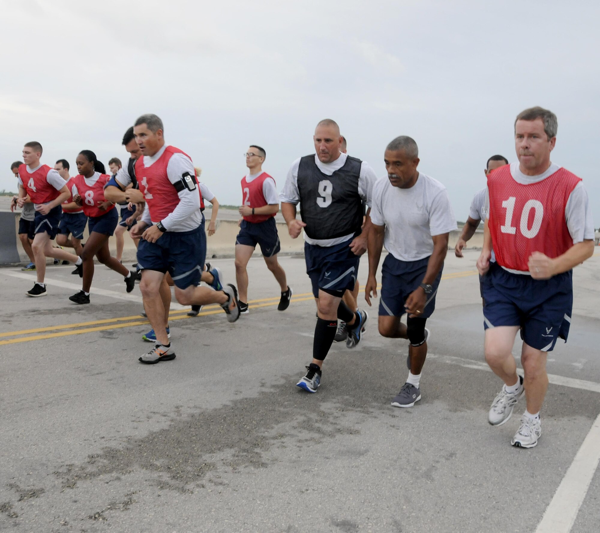 Chief Master Sgt. Mateo, 482nd Civil Engineering Squadron chief enlisted manager, right, motivates Master Sgt. Keith Armour, 482nd CES engineering superintendent, during the run portion of his fitness assessment at Homestead Air Reserve Base, Fla., Aug. 5, 2016. The Air Force Fitness Assessment is a physical performance test used to test endurance and strength of members. (U.S. Air Force photo by Senior Airman Aja Heiden)