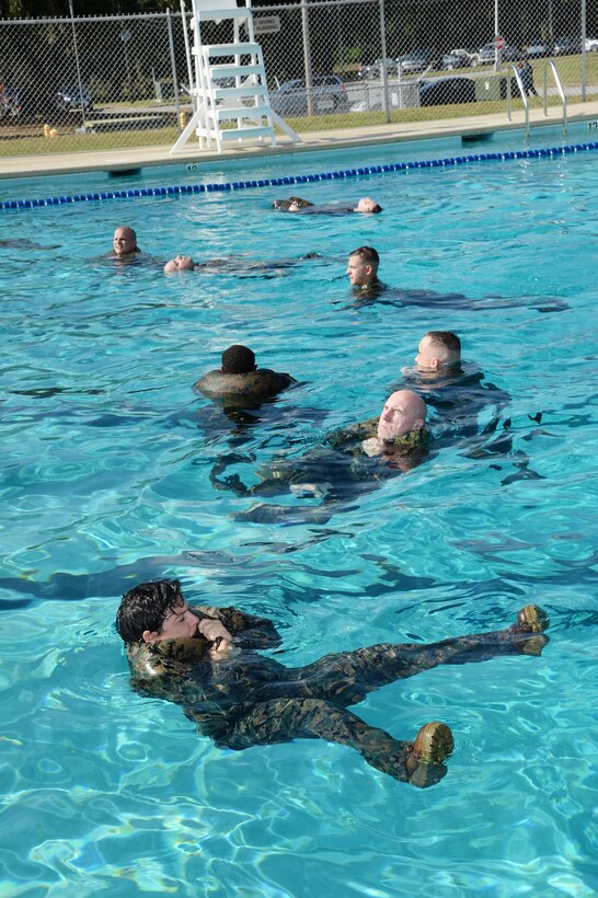 Marines tread water for four minutes during their annual swim qualification at the Base Pool aboard Marine Corps Logistics Base Albany, Aug 24.