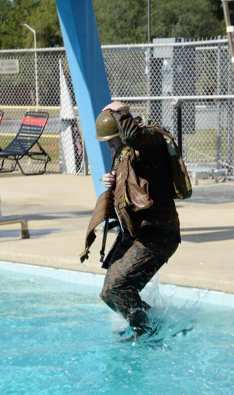 A Marine conducts a deep-water gear shed in the Base Pool as part of the annual swim qualification aboard Marine Corps Logistics Base Albany, Aug 24.
